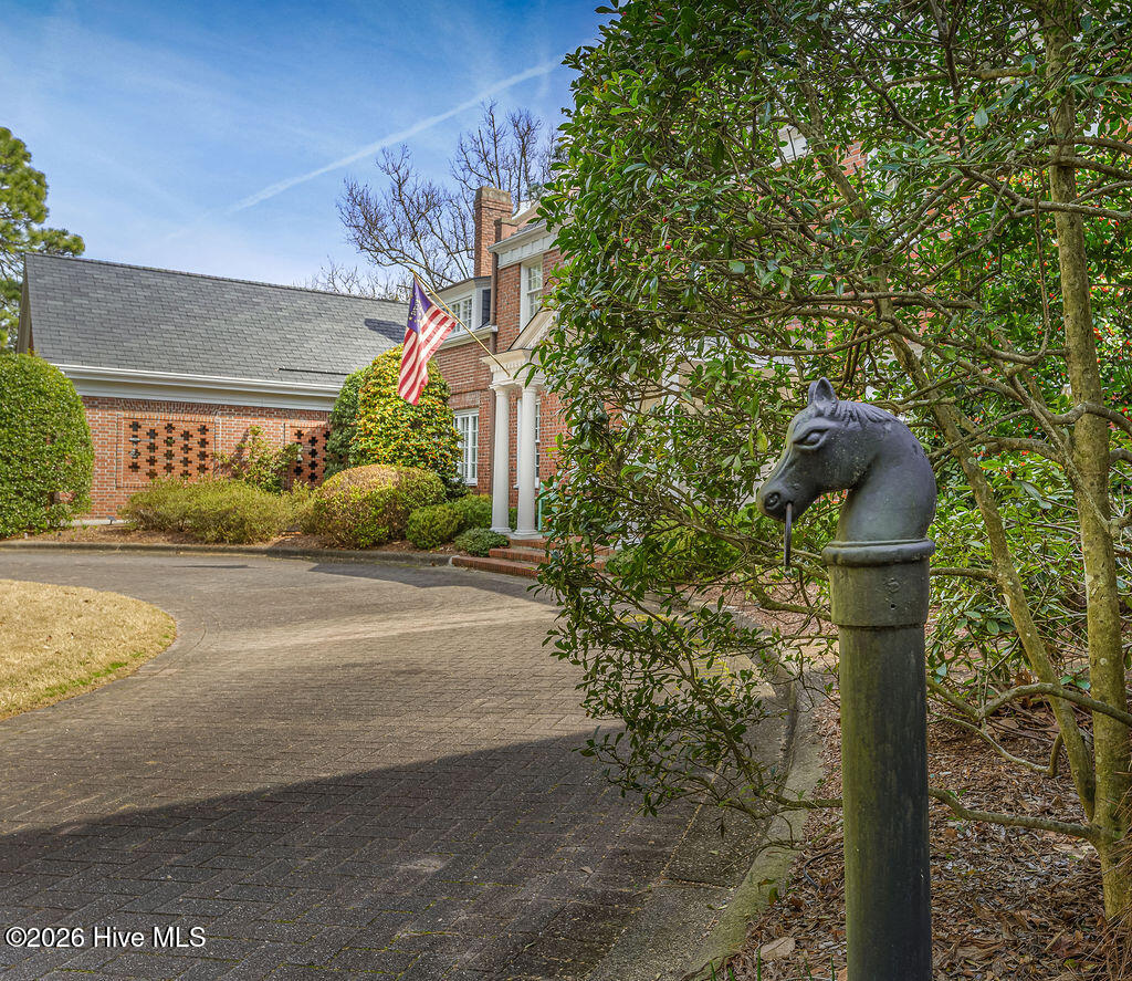 Original cast iron horse-head hitching post at the entry drive