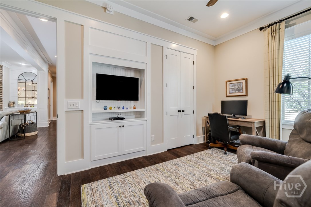 Downstairs den with built ins and storage closet