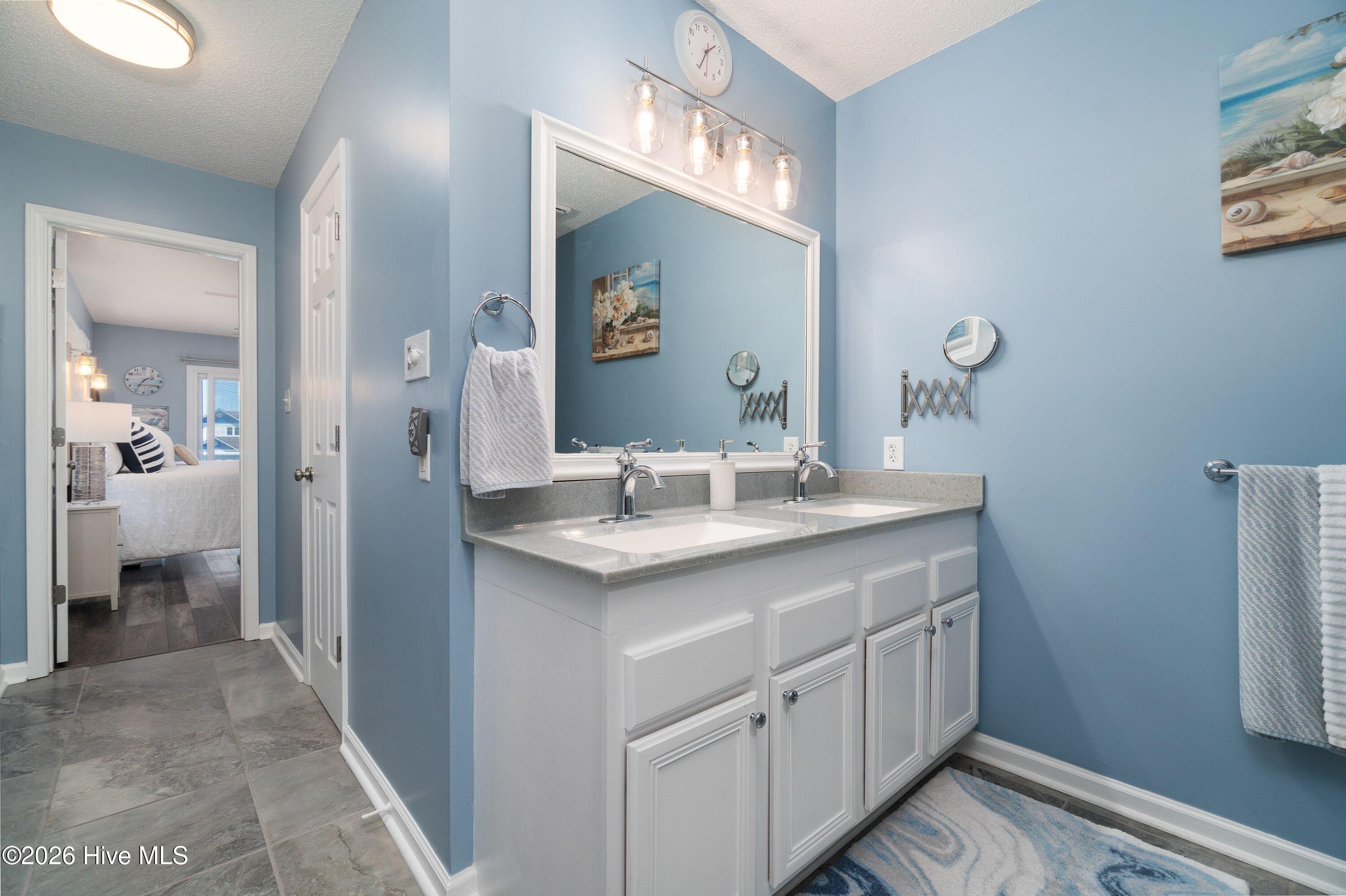 Master Bath with beautiful sea glass type colored counter top ! You have to see it!