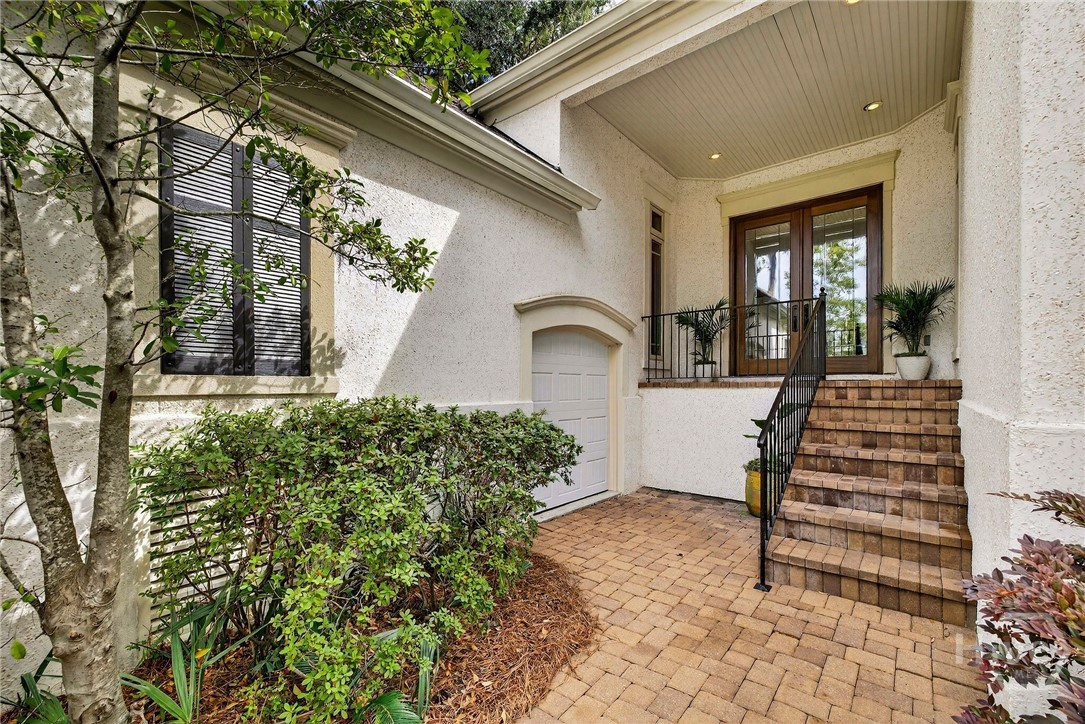 Front of the home with 2 car garage and golf cart