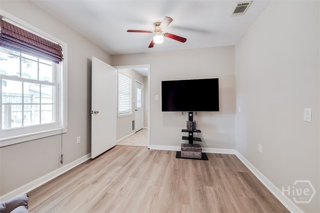 This flex room has new LVP flooring and two ceiling fans.