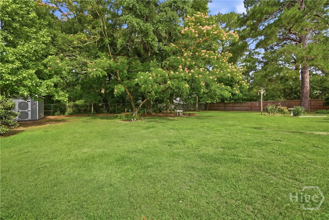 The yard is stunning with its mature trees that pr