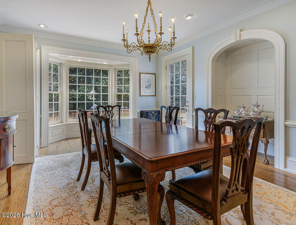 The formal dining room retains its original 1916 frontispiece, arched shell cabinets, and fireplace, preserving one of the home’s most important historic interiors.