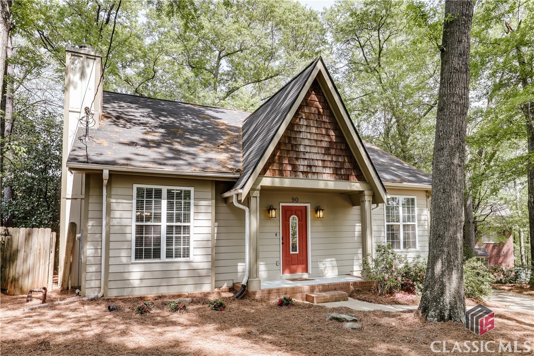 Charming and impeccably maintained, this adorable cottage is nestled in the heart of Normaltown—just a short stroll from local shops, dining, and all the neighborhood favorites. Built in 2004, it offers the modern comforts of newer construction paired with the character and walkability typically found in older homes.

Inside, the open floor plan features soaring 16’ vaulted ceilings, arched doorways, and gleaming hardwood floors throughout the main level. The primary suite is located on the main floor and includes vaulted ceilings, built-in bookcases, a spacious walk-in closet, and a serene feel throughout. The kitchen is both stylish and functional, featuring granite countertops, stainless steel appliances, a pantry, and custom cabinetry. The adjacent dining area includes a cozy built-in banquet, perfect for gatherings.

Upstairs, you’ll find two additional bedrooms and a full bath. A screened-in porch, covered parking, and secure storage for bikes and lawn equipment offer rare and valuable features for the area. The landscaped yard is low-maintenance, and the fully fenced backyard is ideal for pets, play, or entertaining.

Major upgrades include a new HVAC system in 2023 and a new roof in 2024. Move-in ready and full of charm, this is a wonderful opportunity in one of Athens’ most beloved neighborhoods.