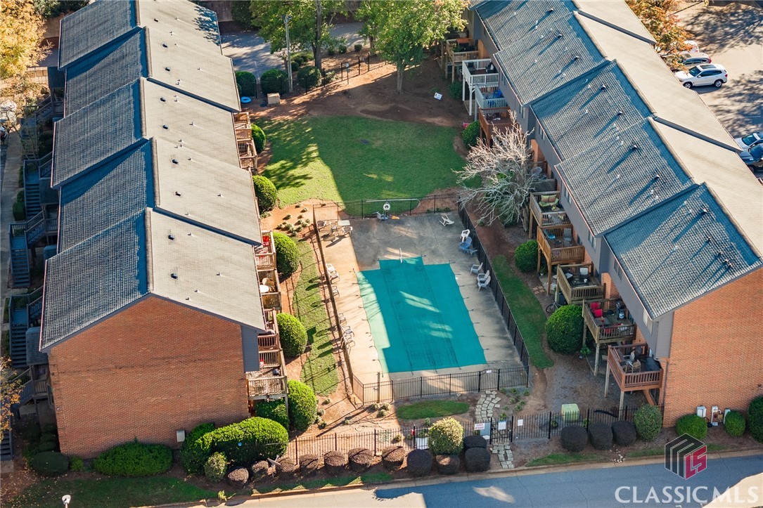 Excellent price point and RARE opportunity to own a condo just one block from Milledge Avenue, a mile from Downtown Athens, and so much more! This end unit, two story condominium is well maintained and leased until end of July 2025 (subject to to tenants rights). Available for Fall 2025 occupancy by the new owner! Save money by purchasing for your college student and avoid monthly rent. The main level of this unit features a bright living room with bay window, a dining area, half-bath, and eat-in kitchen with granite countertops and laundry closet. Through a sliding glass door is the deck that overlooks the pool and courtyard. Again, this is an end unit, so no neighbors to the right! Upstairs are two spacious bedrooms with attached bathrooms. Two assigned parking spaces per unit. Don't miss this unbeatable Five Points/ Downtown location for 310K!