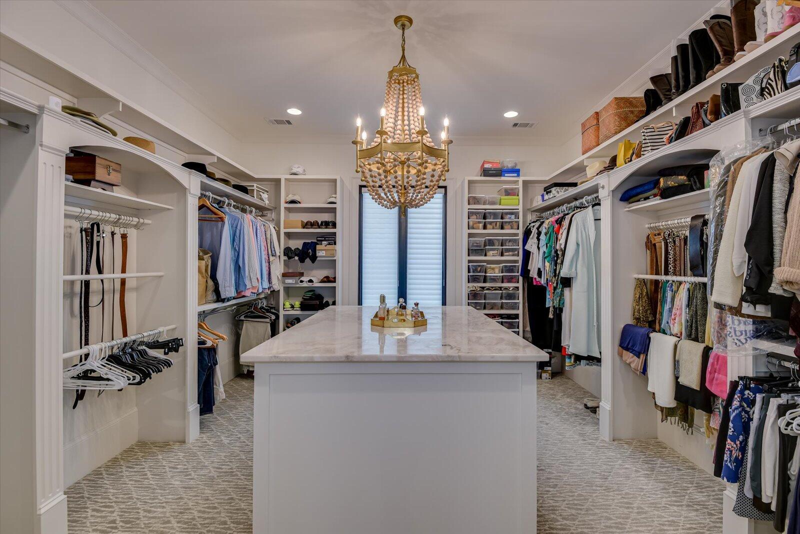Master Closet- Quartzite countertop on center custom dresser. Built-in cabinets.