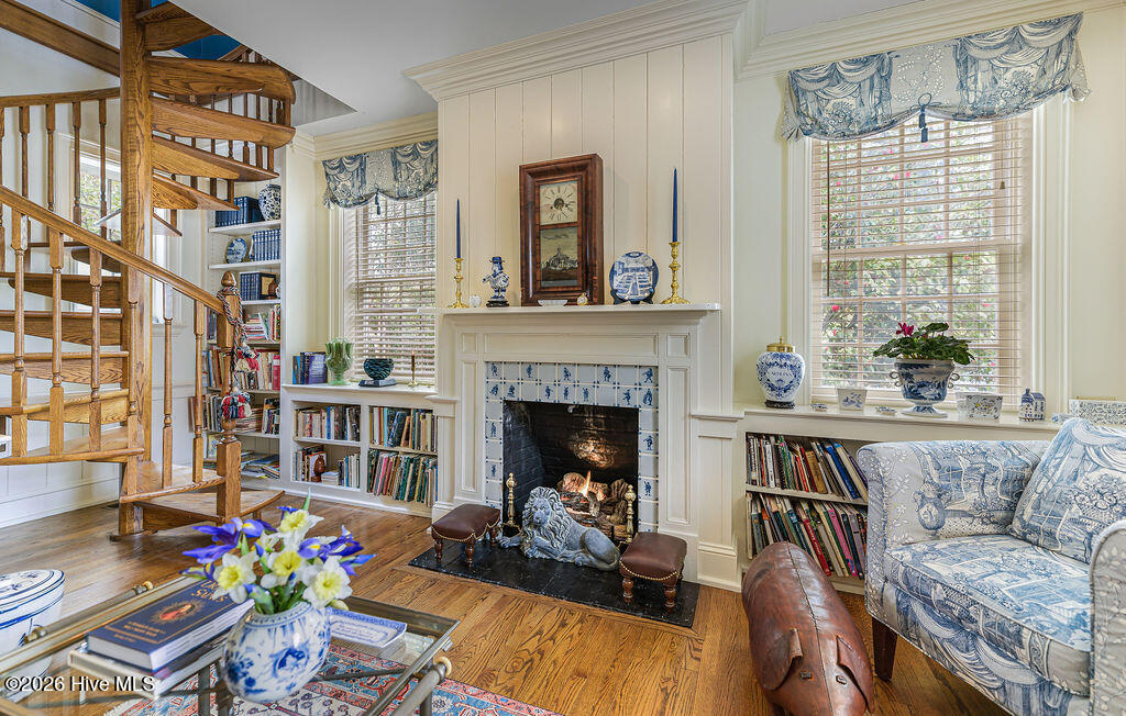 Georgian carved mantel with Delft tile surround and spiral staircase to upstairs Den/Study.