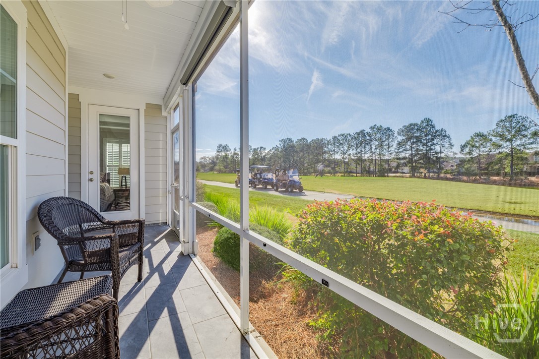 Screened Porch - with view of Primary bedroom access dore with shades