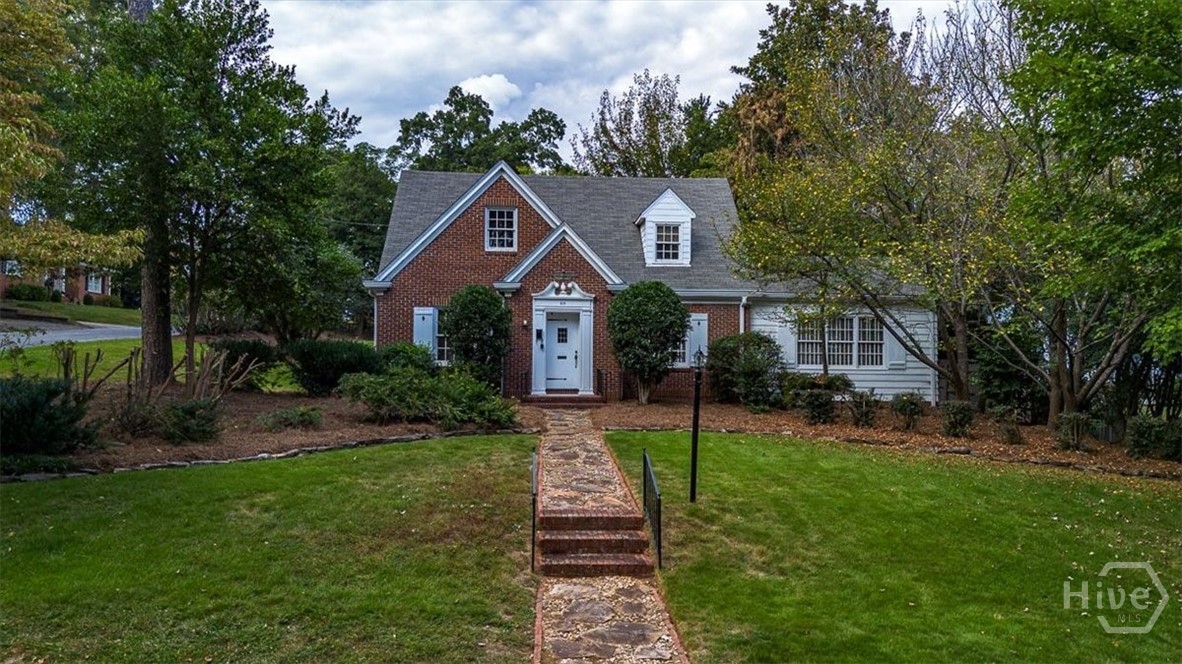 Located in the heart of Athens’ most coveted neighborhood, this distinguished 1940s residence offers timeless charm and exceptional versatility on a beautifully manicured corner lot. Just moments from the University of Georgia and the vibrant Five Points district, the property blends historic character with modern lifestyle amenities in an unparalleled setting.

The main residence features four spacious bedrooms and two and a half baths across two thoughtfully designed levels. Rich hardwood floors, classic architectural details, and abundant natural light create a warm and inviting ambiance throughout. Outdoor living is elevated with a private brick patio and an upper-level retreat complete with a firepit—perfect for entertaining or quiet evenings under the stars.

A rare addition to this estate is the accessory dwelling unit (ADU), offering a screened porch with sweeping views of the expansive grounds. Complete with its own living area, kitchen, bedroom, bath, and laundry, the ADU provides ideal accommodations for guests, extended family, or additional income.

Set within walking distance to tree-lined Milledge Avenue, boutique shopping, fine dining, and cultural attractions, this property presents a unique opportunity to own a legacy home in one of Athens’ most desirable enclaves. With its blend of historic elegance and contemporary potential, this residence awaits the vision of its next discerning owner.