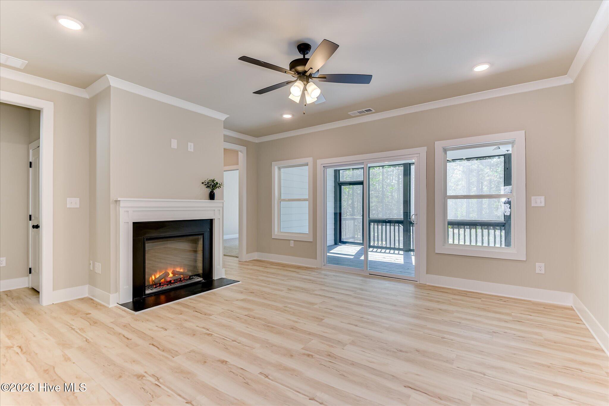 Electric fireplace with sliding doors to rear screened porch