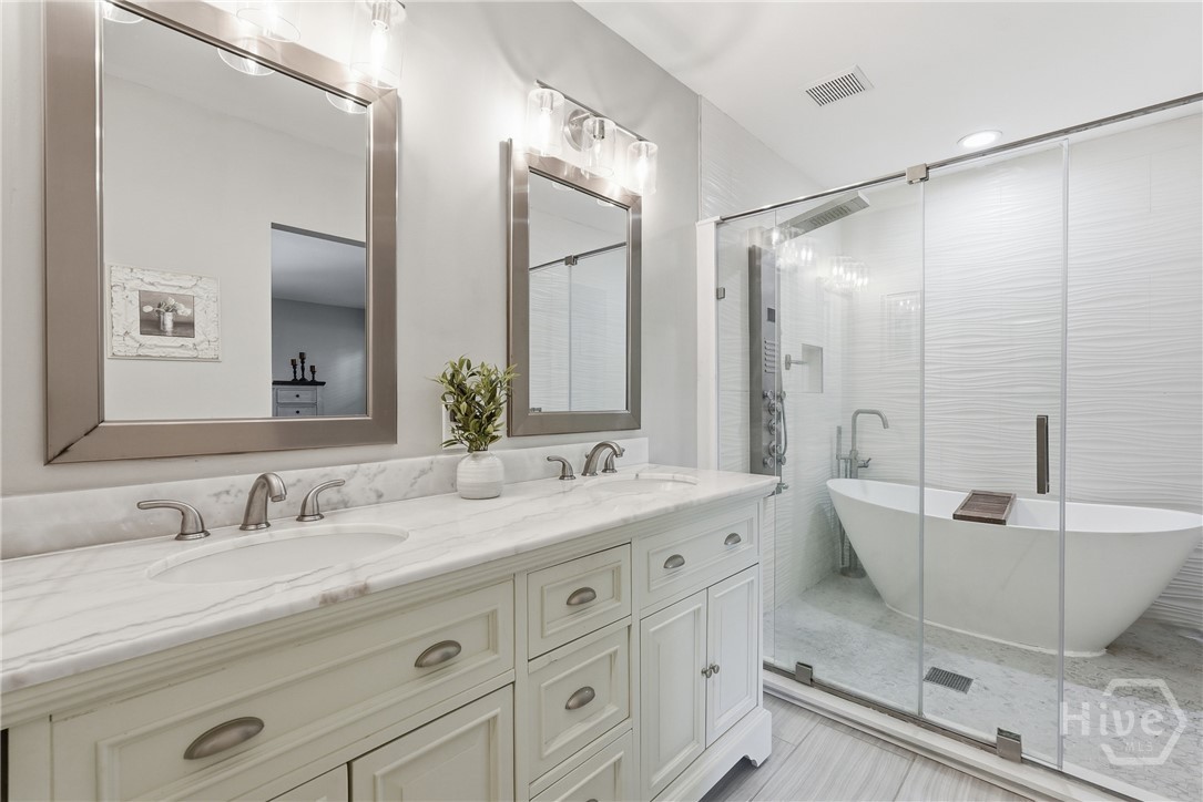Glass enclosed shower with full body sprayer and soaking tub