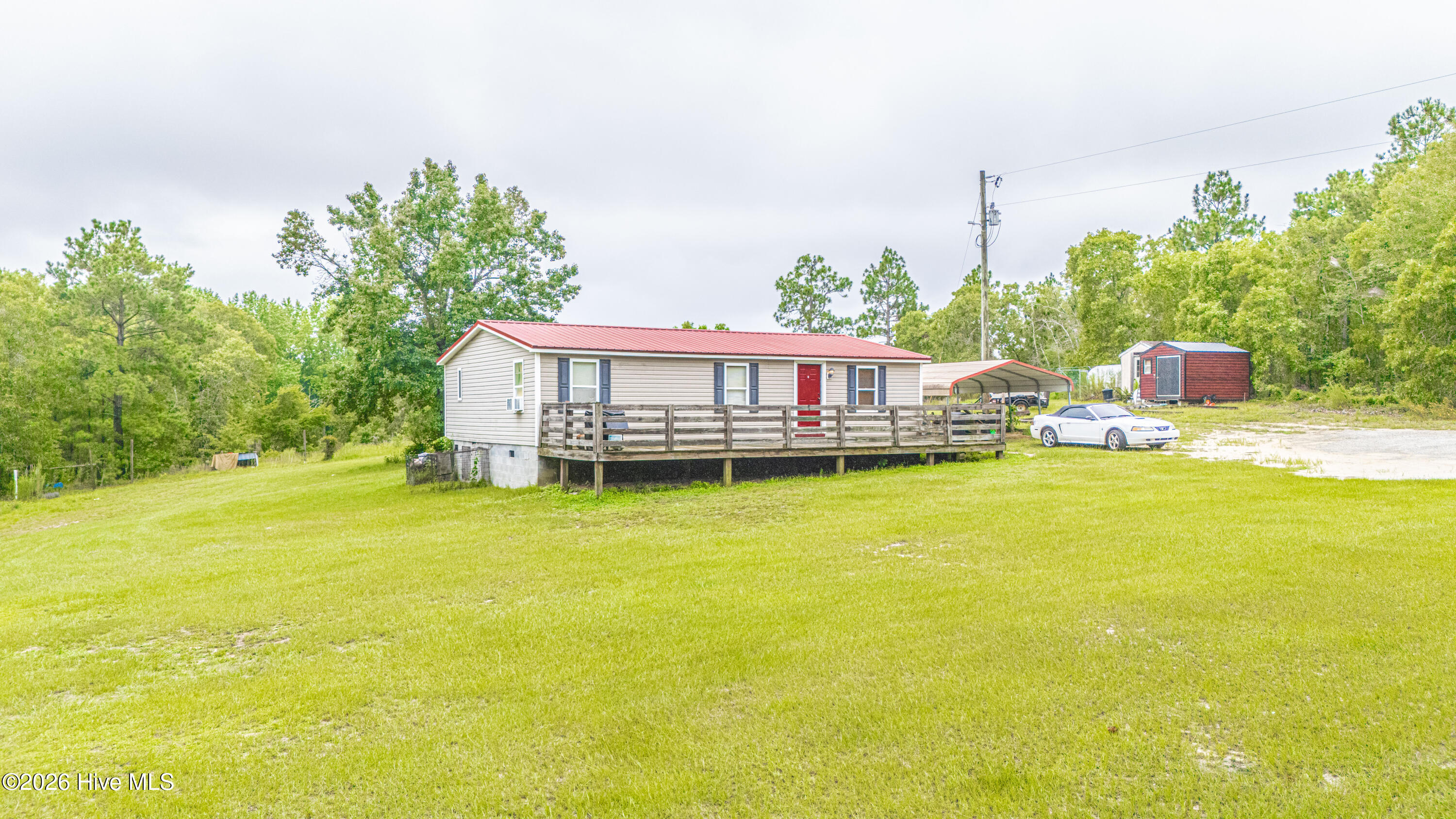 Escape to peaceful country living with this charming 3-bedroom, 2-bath manufactured home situated on 5 beautiful acres just outside the city limits. Offering the perfect blend of privacy and convenience, this property is ideal for those looking to enjoy a quieter lifestyle with room to spread out.Inside, you'll find a comfortable living room that flows into the kitchen, creating a welcoming space for everyday living and entertaining. Recent updates include a new HVAC system for year-round comfort and a durable metal roof for added peace of mind.Step outside to enjoy the expansive acreage featuring a pasture that's perfect for horses or other livestock, giving you endless opportunities for hobby farming or simply enjoying the open space. A carport provides covered parking and additional convenience.