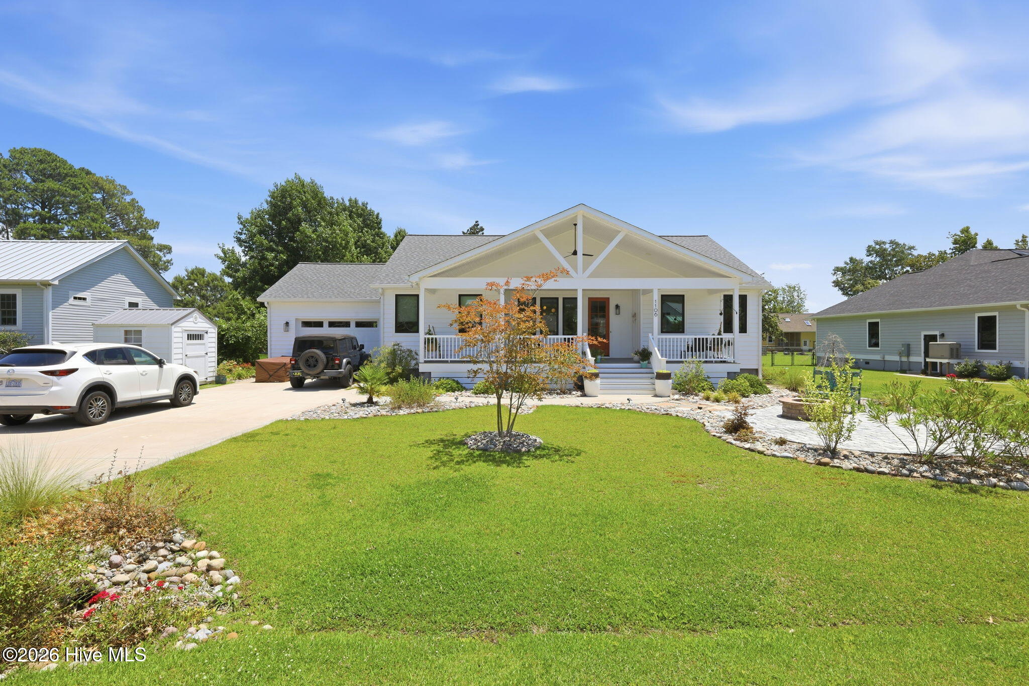 Welcome to a place where life slows down just enough for you to breathe again -- your dream coastal retreat in the heart of Oriental, NC. Custom-built in 2022 and thoughtfully positioned outside the flood zone, this home offers not just safety and craftsmanship, but a sense of ease the moment you step inside.The 10-foot ceilings lift the space around you, creating an airy openness that feels instantly calming. Sunlight pours through the living and dining areas, warming the rooms in a way that makes you want to linger -- morning coffee, quiet evenings, unhurried conversations. A conveniently placed half bath adds comfort for guests without interrupting the flow of the home.The kitchen is where this home truly speaks to the heart. Quartz countertops catch the light like sea glass. Custom cabinetry and a generous pantry keep everything beautifully organized. The counter-to-ceiling tilework adds a touch of artistry, while the large windows flood the space with natural light, making even simple moments -- slicing fruit, pouring a glass of wine, prepping dinner -- feel special.The primary suite is your private retreat. Remote-controlled shades let you wake gently with the sun or sleep in without a care. The spa-like bathroom, with its walk-in shower and dual vanity, invites you to slow down and unwind. And the spacious walk-in closet offers room to breathe, to organize, to settle in.Guests will feel genuinely welcomed in the second bedroom, complete with its own private entry, ensuite bath, and a charming coffee bar with a fridge and microwave. It's the kind of thoughtful detail that makes visitors feel cared for -- and makes hosting a joy.Even the everyday spaces are designed to make life easier. The large laundry room with its shiplap drop zone turns routine tasks into something almost enjoyable. The dedicated mechanical room keeps essentials tucked away neatly, adding to the home's sense of order and calm.Step outside and you'll feel the true spirit of coastal living. The wide front porch invites slow mornings, neighborly chats, and the kind of peaceful moments you'll look forward to every day. The fire pit area becomes the heart of cool evenings -- laughter, stories, stargazing. And the back deck is perfect for grilling, al fresco dinners, or simply letting the breeze wash over you after a long day.Just minutes from restaurants, shops, the waterfront, and all the charm that makes the Village of Oriental so beloved, this home offers the rare combination of tranquility and convenience. It's not just a place to live -- it's a place to belong.Don't miss the chance to experience a home that blends coastal charm, modern comfort, and emotional warmth in every detail. Schedule your tour today and imagine the life waiting for you here -- peaceful mornings, breezy afternoons, and evenings filled with the simple joys of living in Oriental.