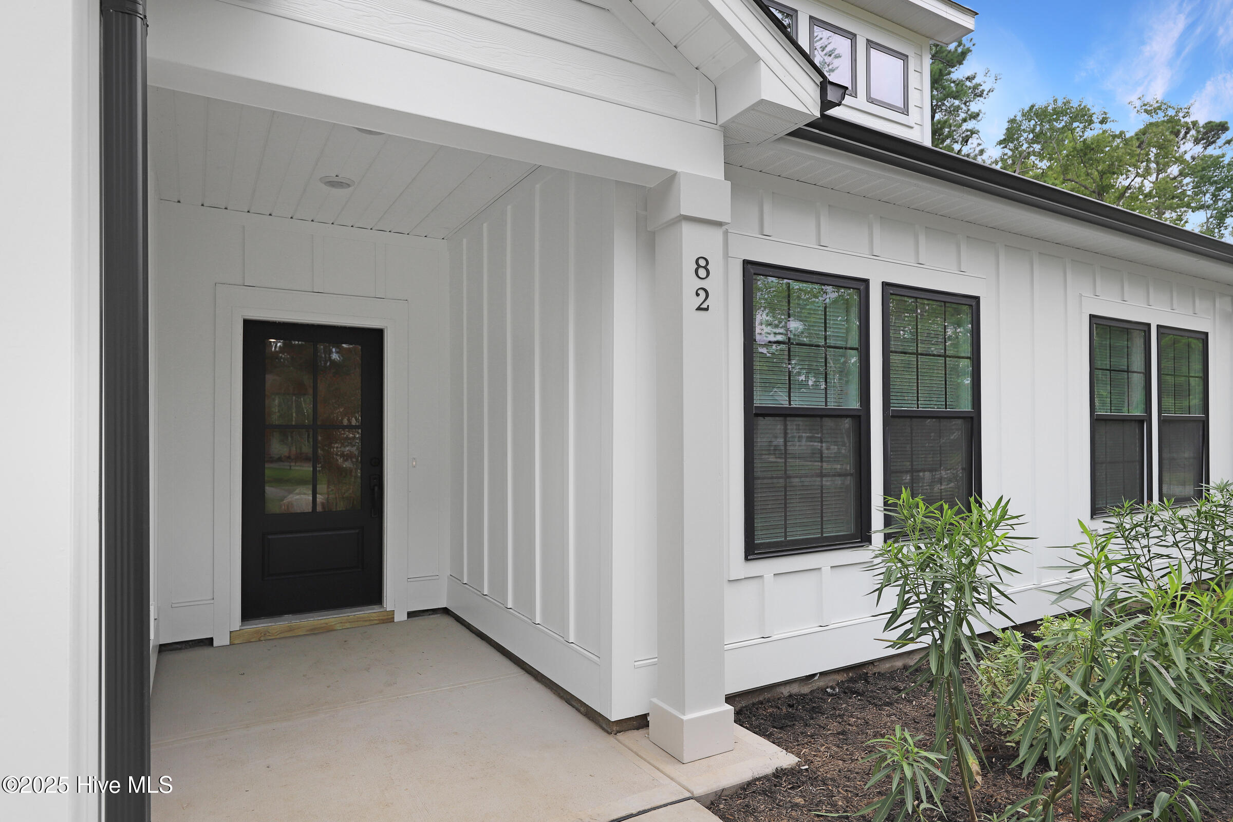 82NE Front entry & siding