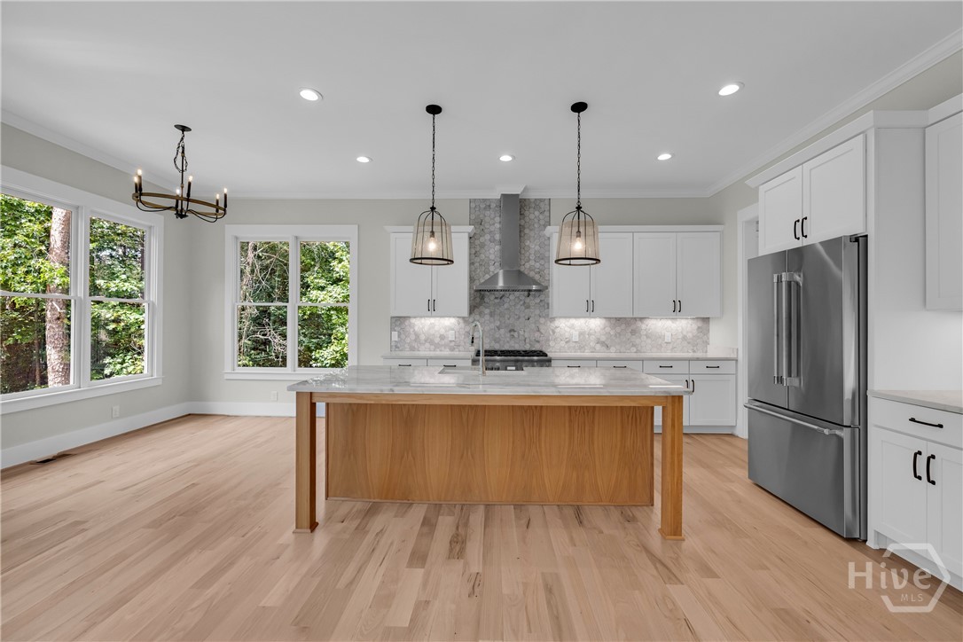 Stunning chef’s kitchen featuring marble and quartz countertops, a complete Thermador stainless steel appliance package, 5-burner natural gas cooktop, dedicated coffee station, and an impressive butler’s pantry for added storage and entertaining convenience