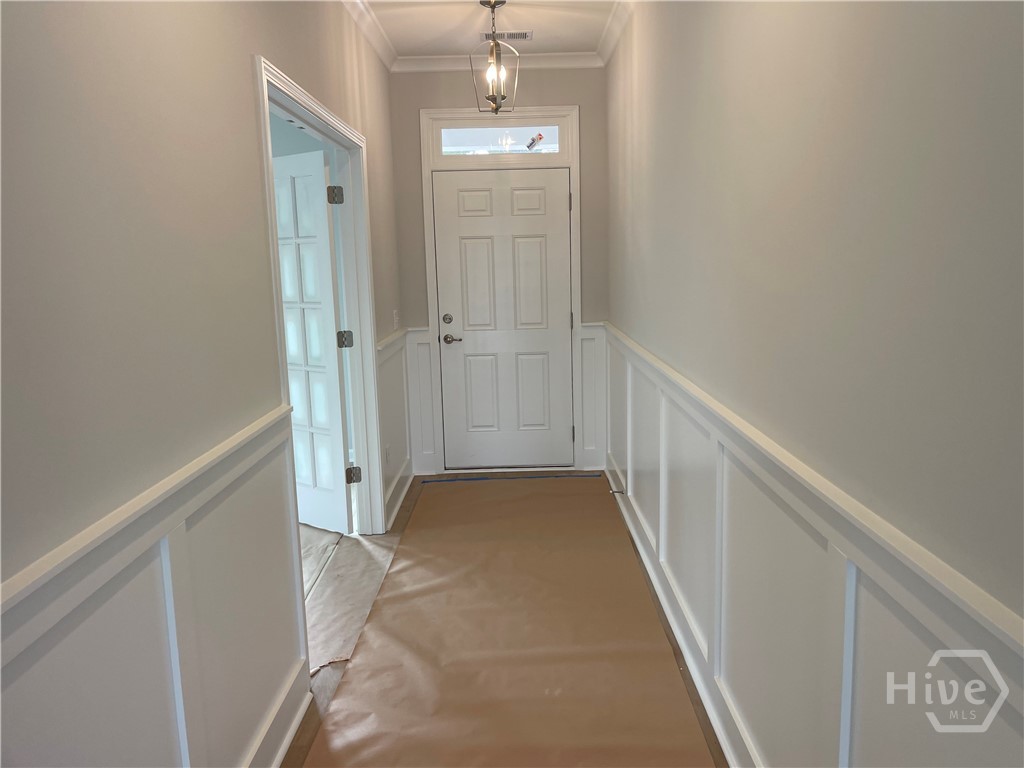 Wide Foyer with Wainscotting and Crown