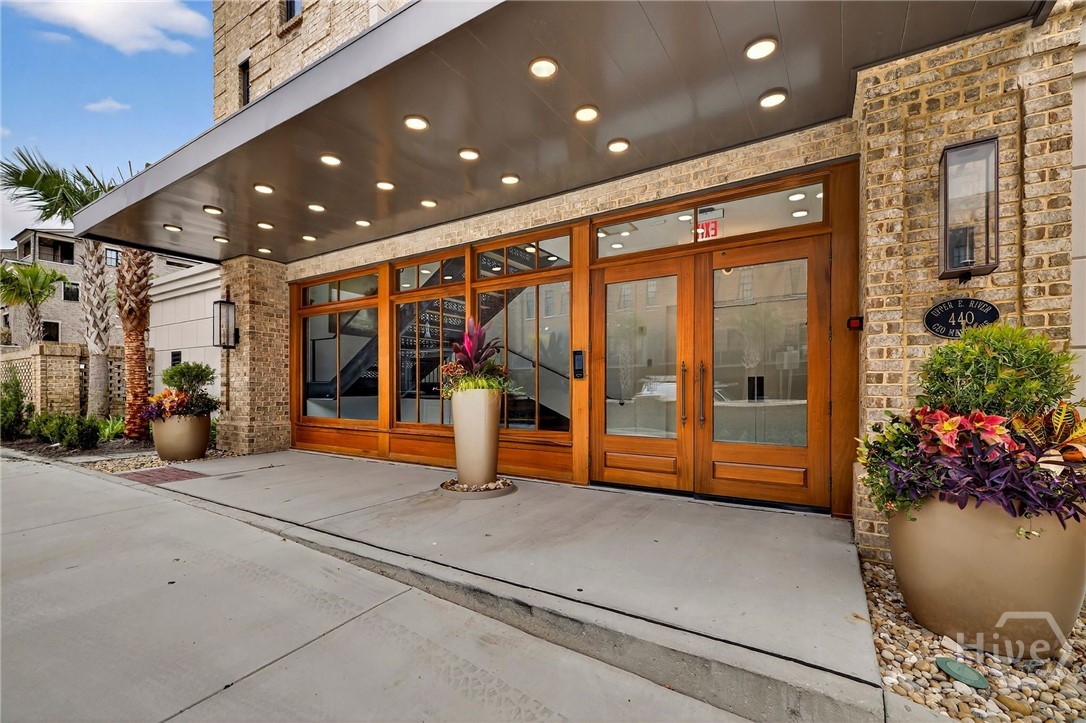 Mayors Condominium - This stately riverfront residence boasts a commanding brick facade, private balconies, and scenic views-an elevated blend of historic charm and natural serenity.