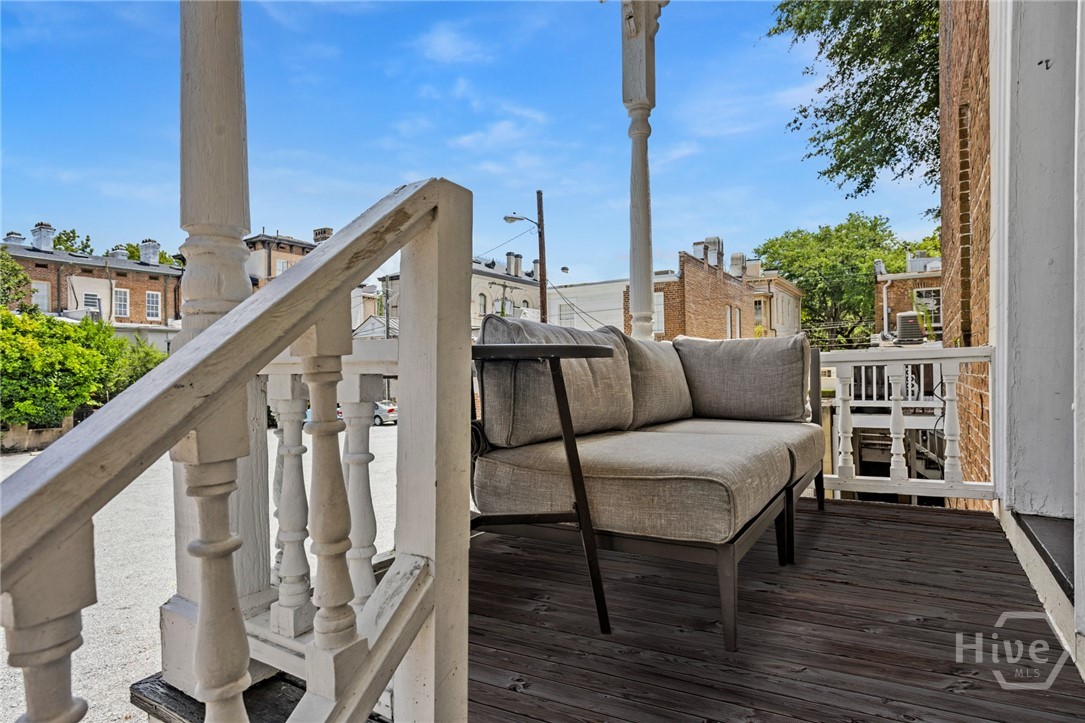 Covered front porch/entrance to upper apartment.