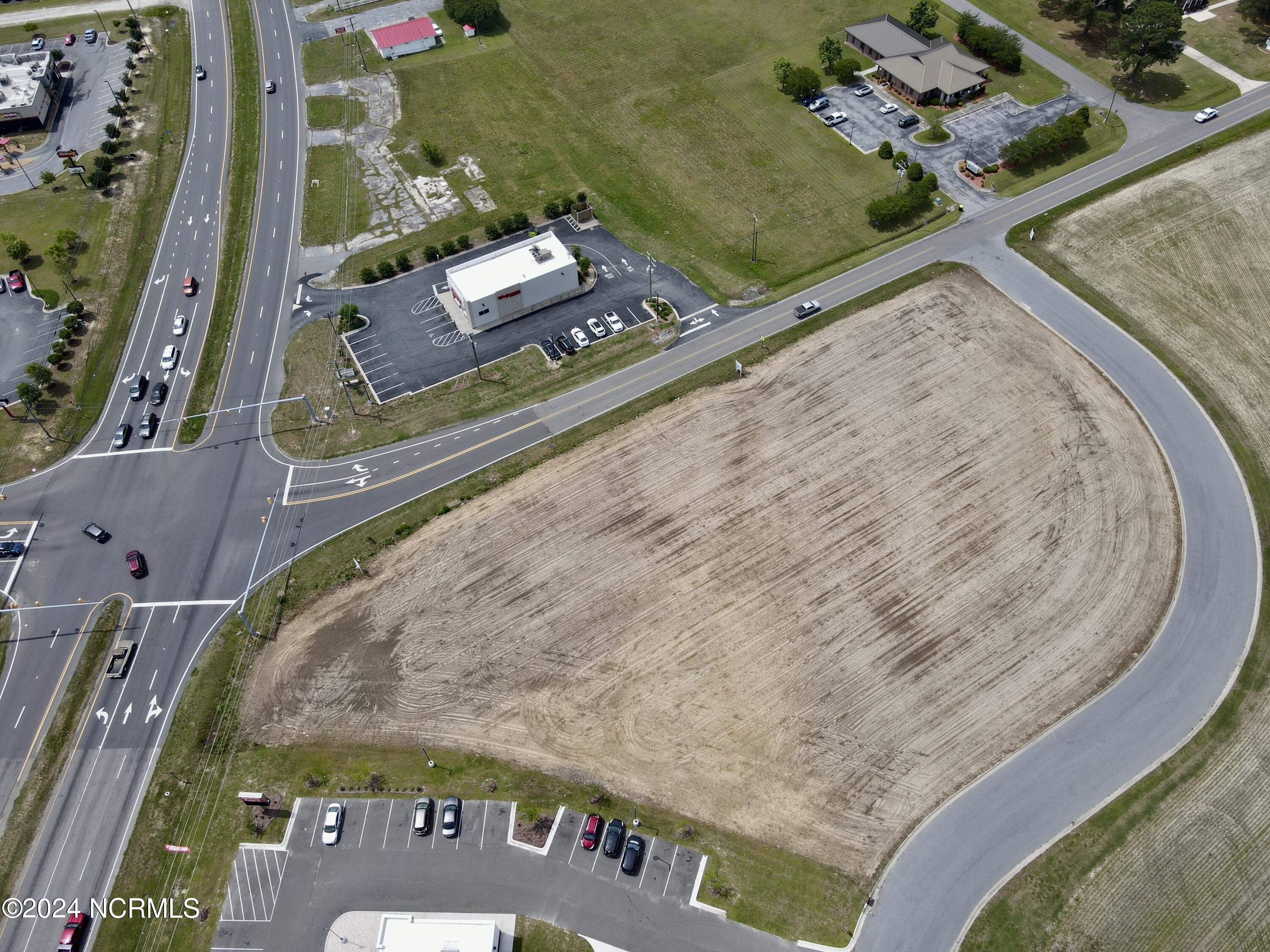 Sweetwater Real Estate Inc is delighted to offer a prime 1.10-acre commercial land parcel for sale in Williamston, North Carolina. This exceptional property is strategically located adjacent to a high-performing Walmart retail center, benefiting from strong sales and consistent daily foot traffic. 
Boasting 261 feet of frontage along US Hwy 17 and Garrett Road, the site offers convenient access via Brentway Avenue, making it highly accessible for potential development. Zoned for highway commercial use, this property is suitable for a wide range of business opportunities.
The surrounding area is a bustling hub of national and local businesses, including Walmart, Pizza Hut, KFC/Taco Bell, Cookout, Murphy Gas Station, Walgreens, Carolina Quick Care, and Hardee's. With an average daily traffic count exceeding 11,000 vehicles, the site enjoys excellent visibility and exposure. 
Conveniently situated near the interchange of US Hwy 64 and US Hwy 17, the property is just 3 miles from Downtown Williamston and only 1 mile from the US Hwy 64 & US Hwy 17 intersection. This lot could be combined with the adjoining parcel that is also for sale for a total of 2.10 acres. This prime location offers unparalleled business potential in one of Williamston's most sought-after commercial areas.