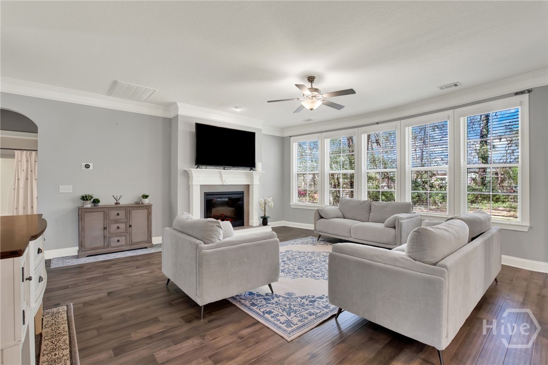 Family Room with Fireplace and Curved Wall of Windows