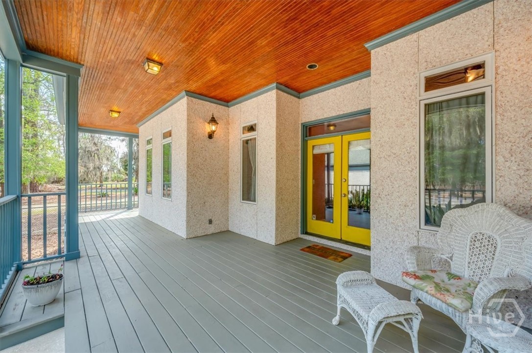 Covered Front Porch with stained tongue and groove ceiling and Tabby exterior