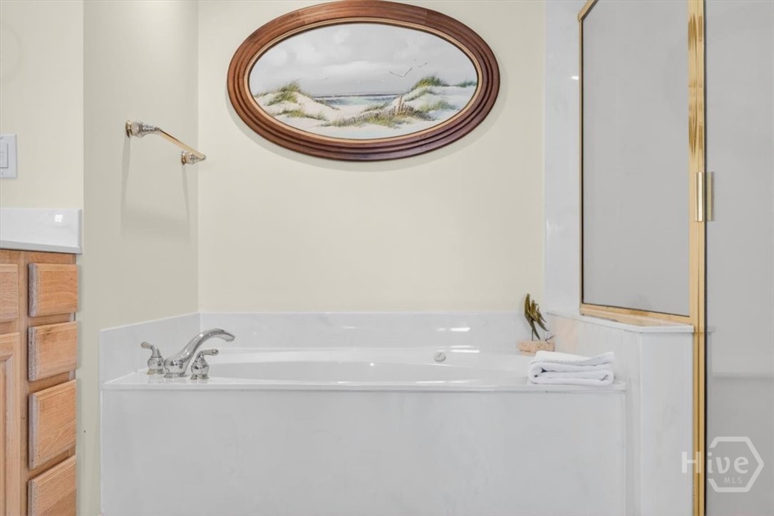 Huge primary en-suite offers ample closet space, a soaking tub, double vanities, and separate shower