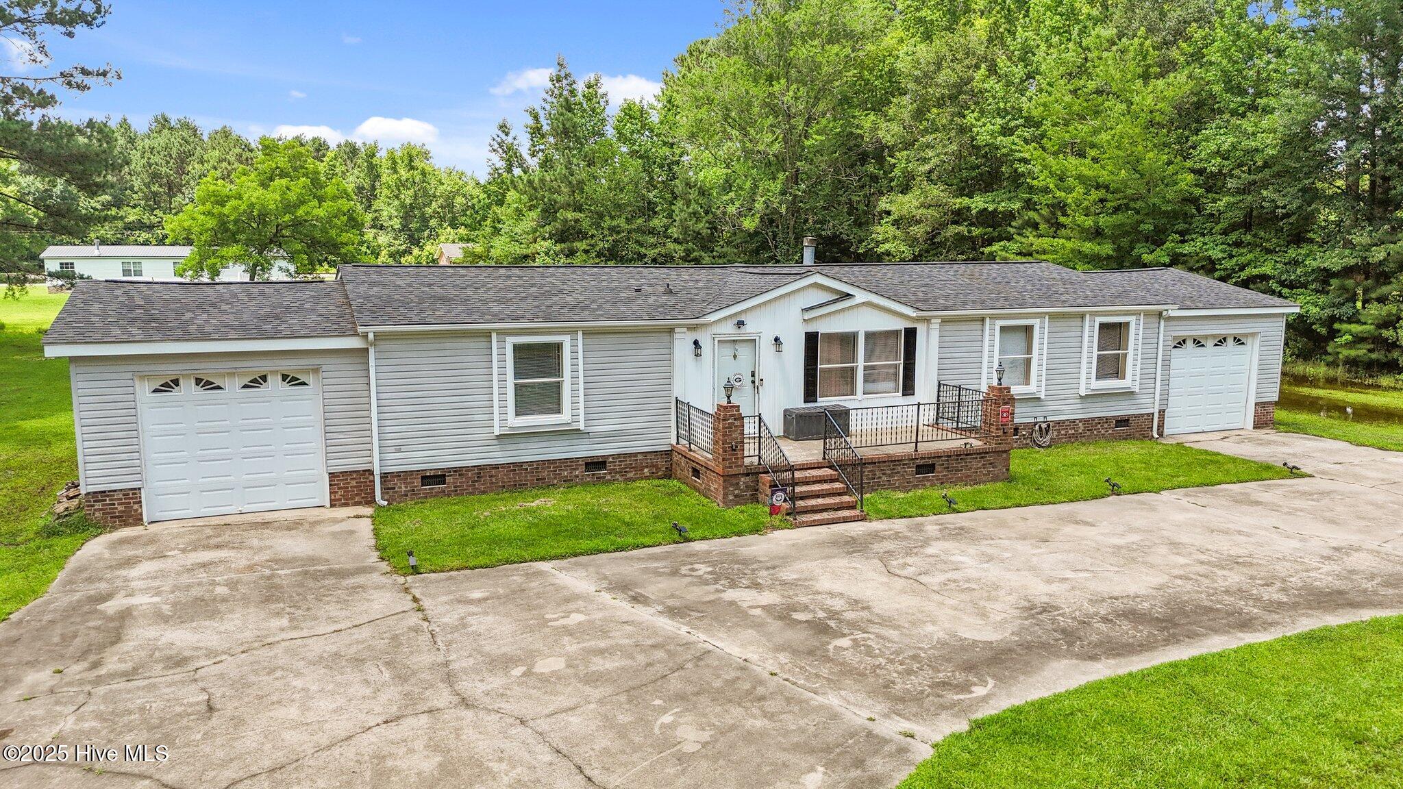 ** BACK ON THE MARKET!!*** At no fault of the seller, or the home!!  Beautiful 3 Bedroom 2 Bathroom Home on 1.8 acres in the heart of Parmlee, NC! This home features 2 living areas, with fresh carpet in the front living room; A spacious kitchen with large island; fireplace in back living room with built ins around it; 2 single car garages with electric roll up doors; 
A concrete circle driveway; and a large yard. Come check it out while you can!