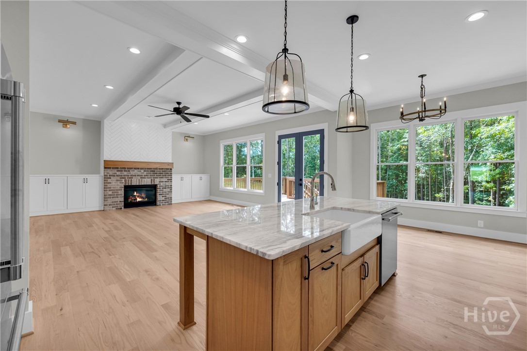 Stunning chef’s kitchen featuring marble and quartz countertops, a complete Thermador stainless steel appliance package, 5-burner natural gas cooktop, dedicated coffee station, and an impressive butler’s pantry for added storage and entertaining convenience