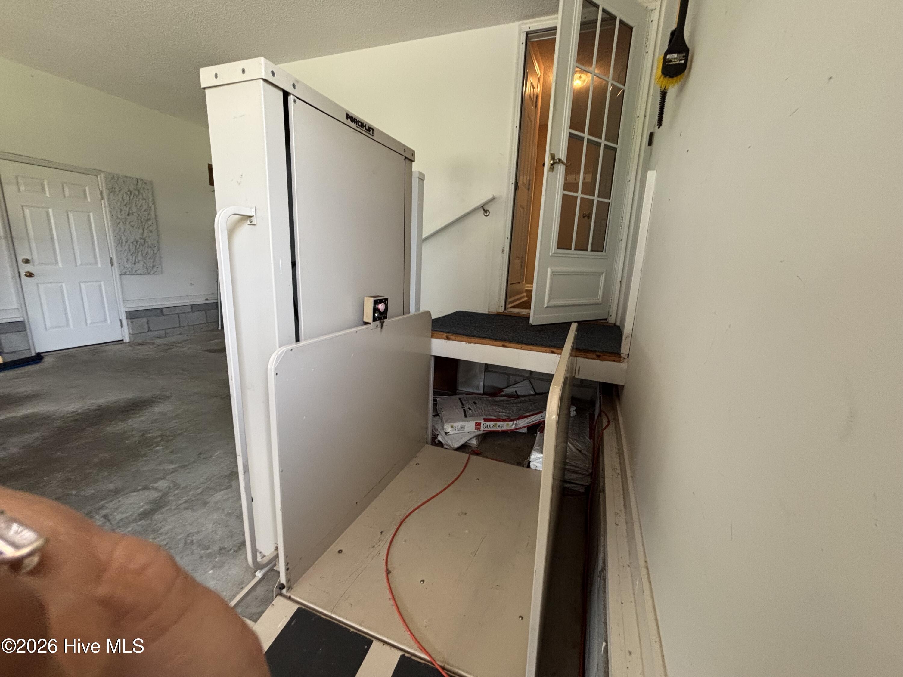 Wheelchair lift in garage conveys