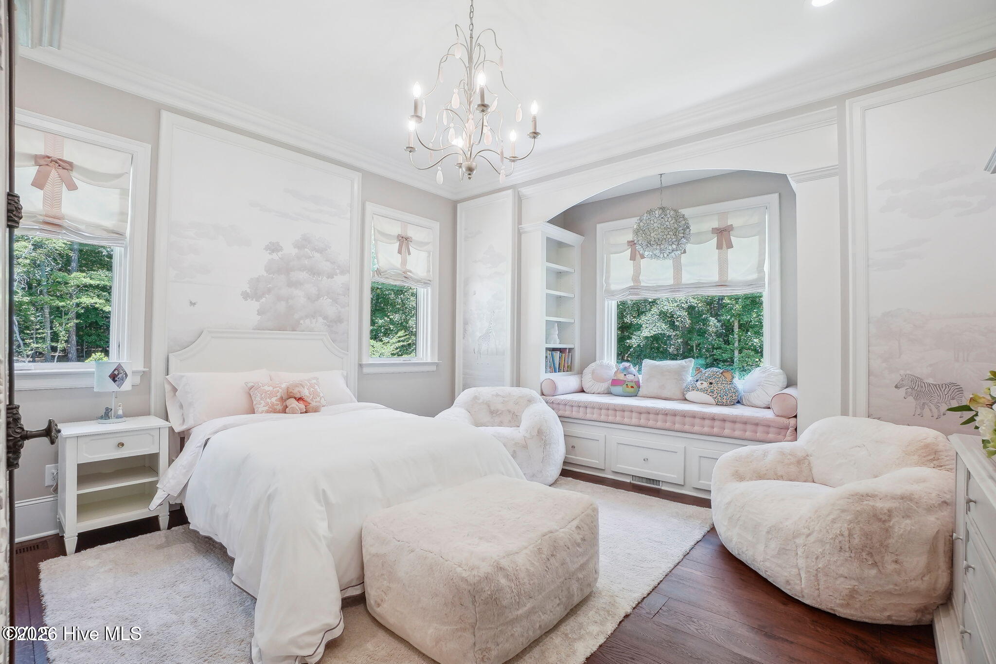 First floor guest bedroom/child's bedroom with built-in window bench seat and custom-made cushions a