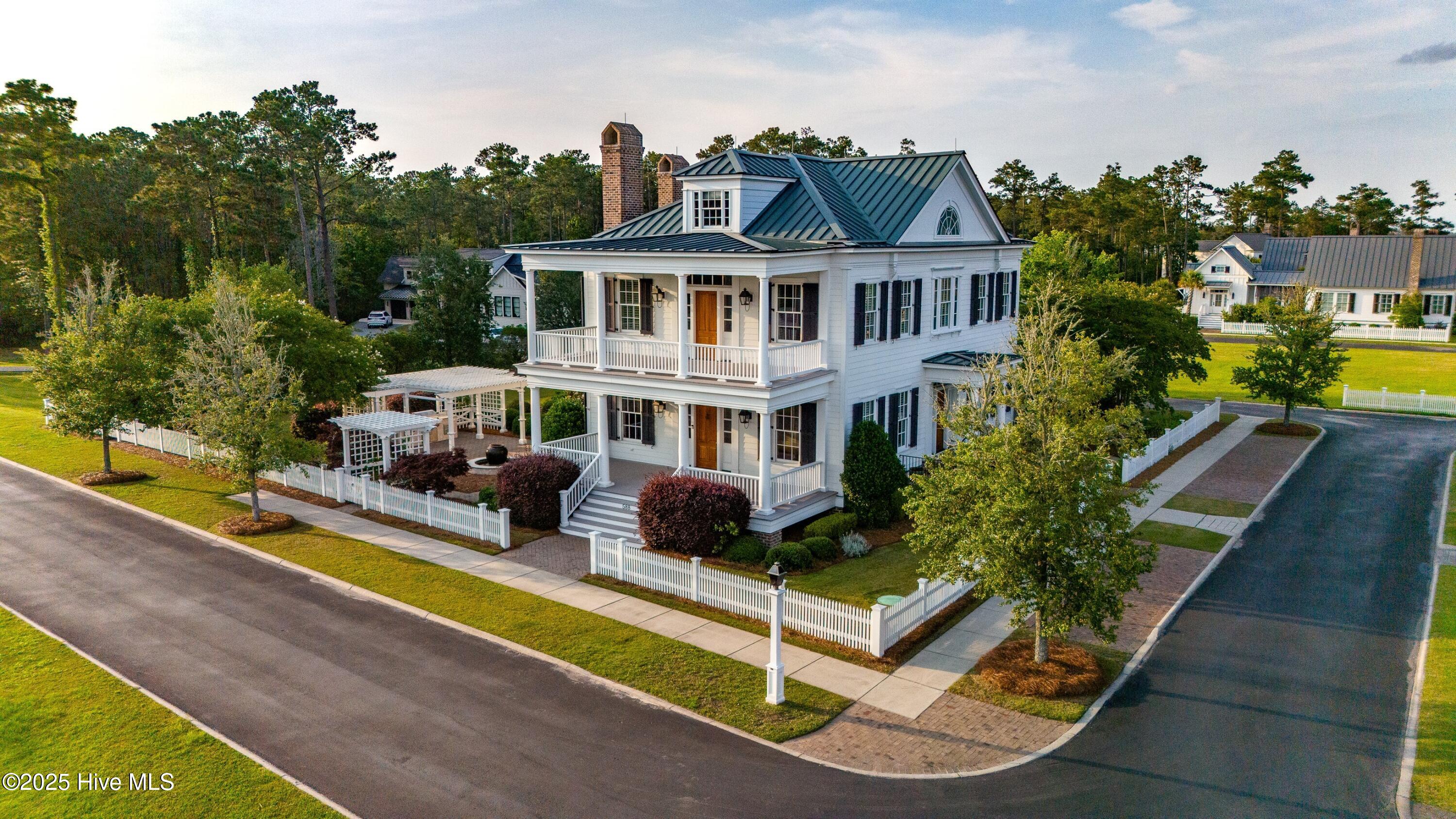 588 E Harborside Road Oriental, North Carolina Refined Coastal Living on the ICW. Designed by Historical Concepts, this timeless home in River Dunes offers exceptional craftsmanship and direct access to some of the best boating waters on the East Coast. Set on a premier double lot overlooking a protected harbor just off the Intracoastal Waterway, this residence is a boater's dream offering quick access to the Neuse River, Pamlico Sound, and beyond. Classic architecture meets modern luxury throughout: antique heart pine floors, detailed wainscoting, dramatic windows, and deep front and side porches that extend your living space outdoors. Brick fireplaces in the living and keeping rooms, a sophisticated kitchen with Wolf, Thermador, and Viking appliances, and a butler's pantry add elegance and functionality. Enjoy stunning harbor views from the primary suite and multiple outdoor living spaces including multiple covered porches, summer kitchen, firepit, pergola, and water feature. The third floor offers a flexible retreat with a full bath and built-ins. The carriage house offers garage space for up to four vehicles, complete with a lift. A separate garage includes a private guest suite above for added comfort and privacy. Located in a Southern Living-Inspired Community with 14 miles of shoreline and a top-rated marina, this home is your gateway to year-round boating and refined coastal living in Oriental, NC.