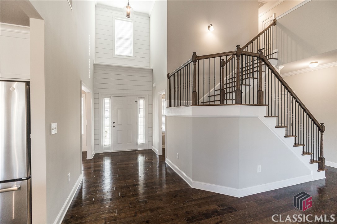 Beautiful Coldwater Creek home just hit the market in Watkinsville!! This four-sided brick home features 4 bedrooms, 2.5 bathrooms, and 2273 sq ft of living space. The first floor features an open-concept layout with a large two-story living room with a fireplace open to the kitchen and breakfast area. The kitchen comes equipped with stainless appliances, granite countertops, and a large island. There is another formal dining area that could also be a wonderful home office location. There is a large primary suite that is also located on this main level. Upstairs you will find 3 additional bedrooms with a central bath. The backyard is fenced in and backs up to the neighborhood HOA-protected buffer for added privacy. This home has a walk-in laundry room with plenty of storage throughout the home and in the 2-car garage. Throughout the home, there is hardwood flooring (zero carpet) and fresh interior paint. This home is move-in ready today!