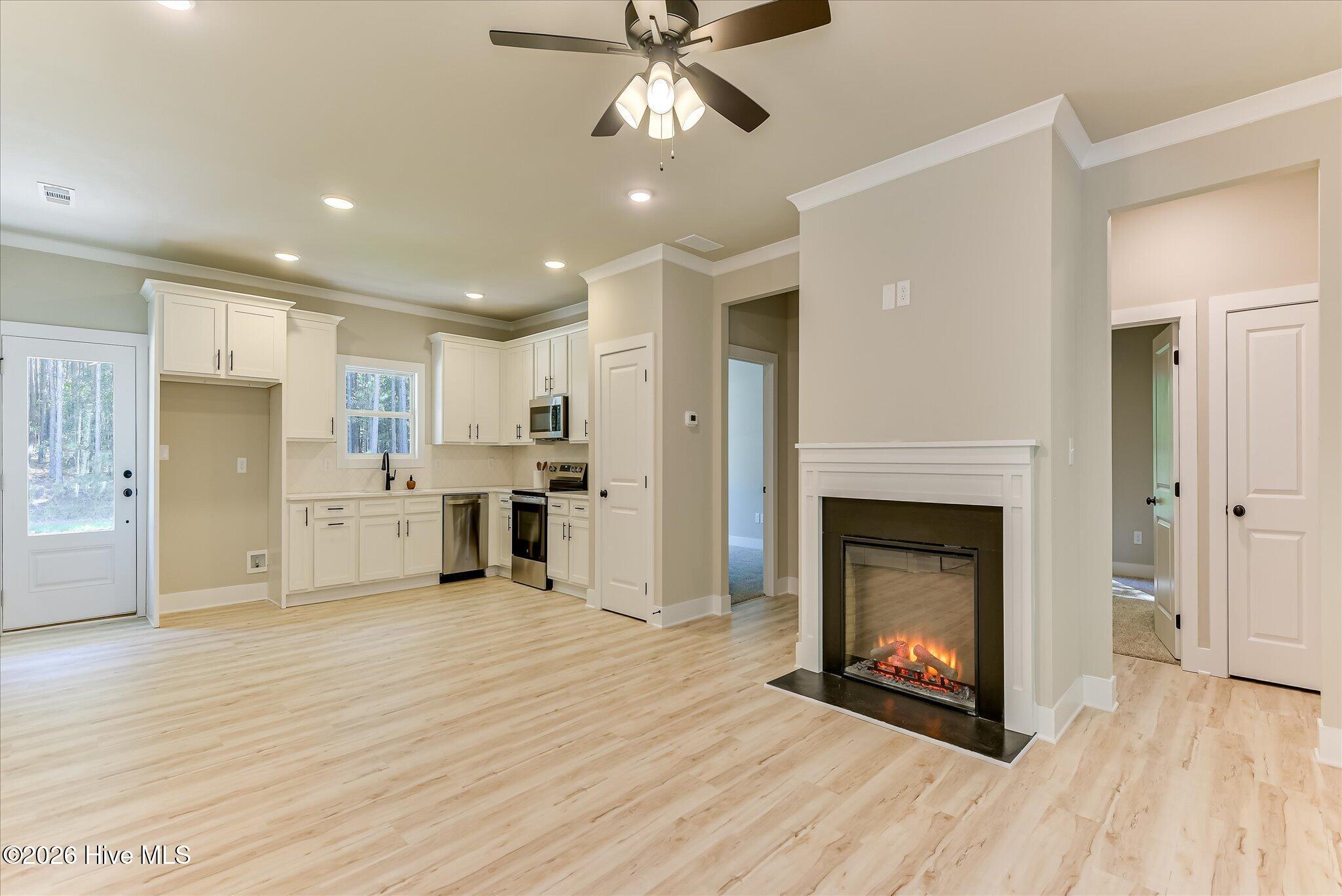 Open, split floor plan, kitchen/living/dining, hallway to Guest Bedrooms