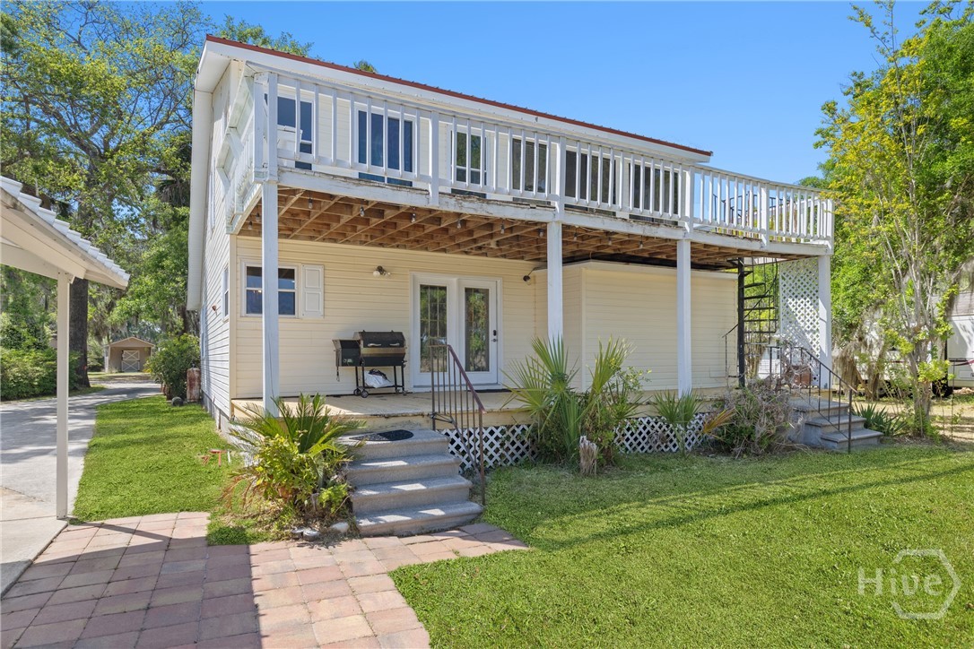 Rear exterior view showcasing elevated deck and ad