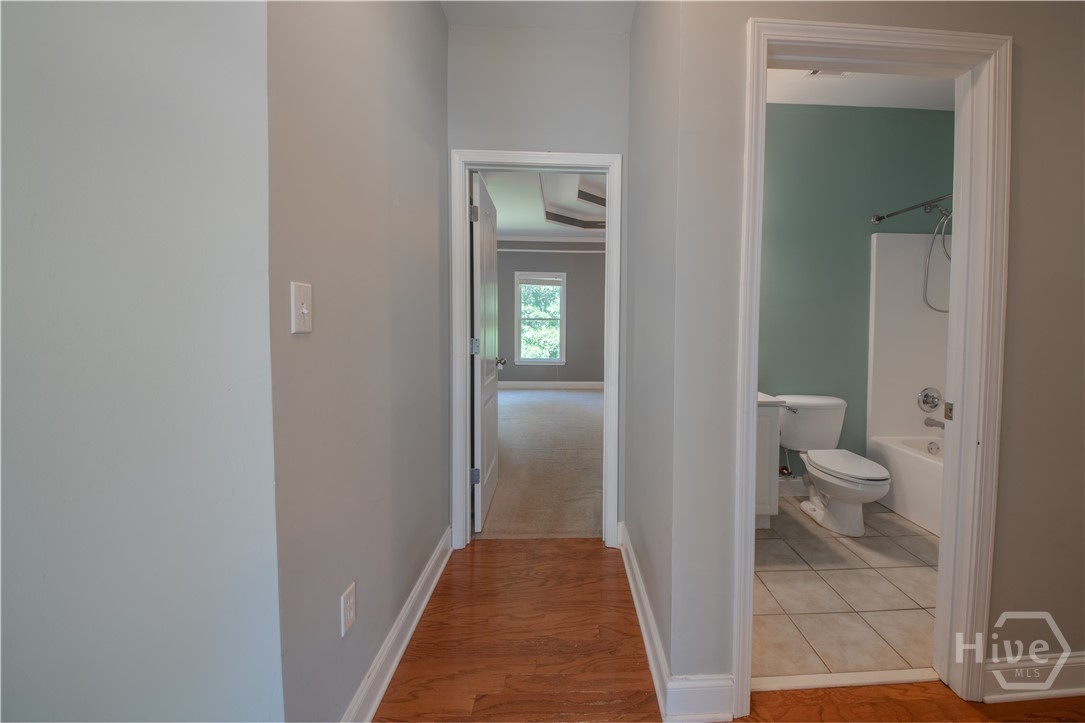 Hallway to Primary Suite, Hall Bath and Additiona Bedrooms