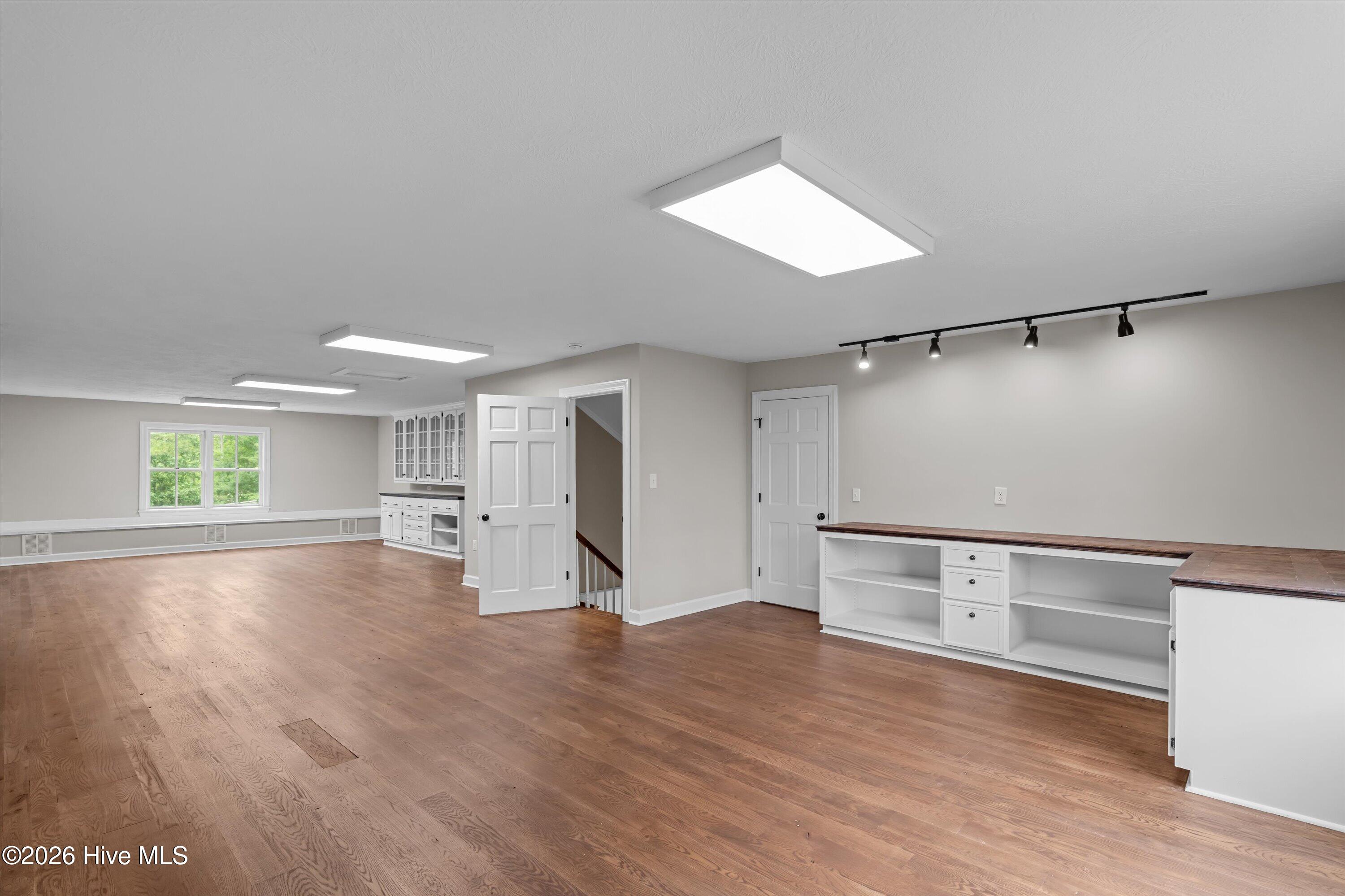 Spacious third floor space with over 800 sq feet perfect for 5th bedroom, media room, or multiple room setup
