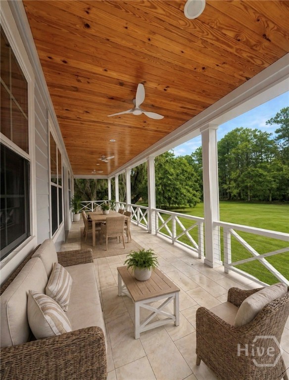 A beautiful terrace on the back overlooks a large backyard. Photo is virtually staged.
