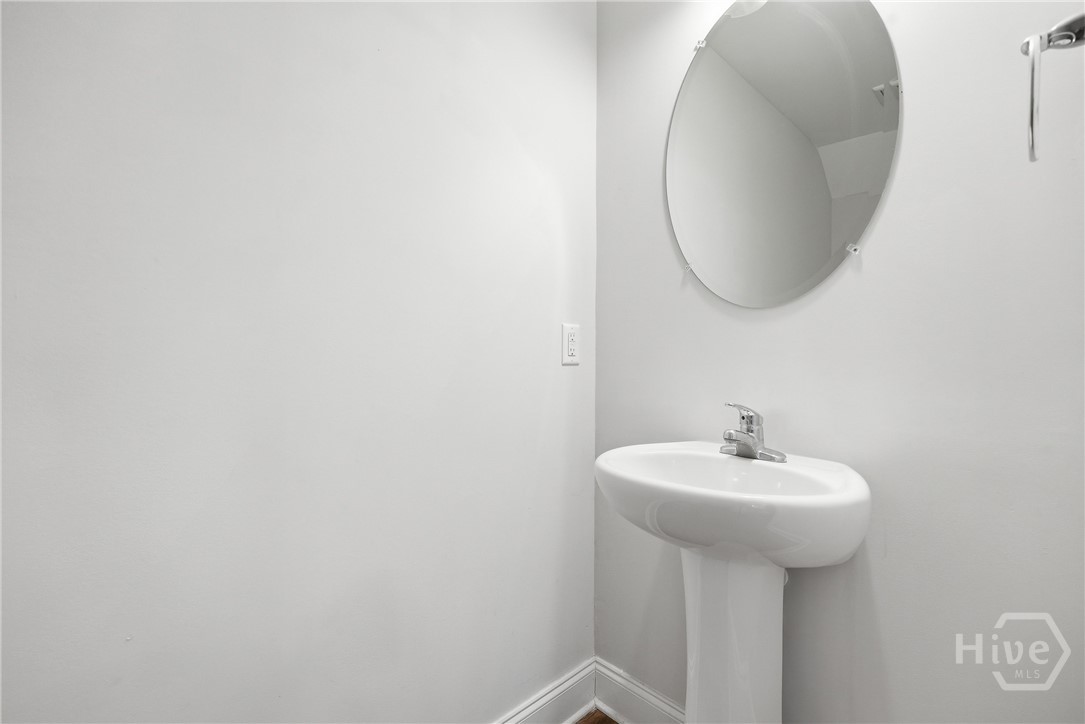 Powder room for guests is right of the living room.