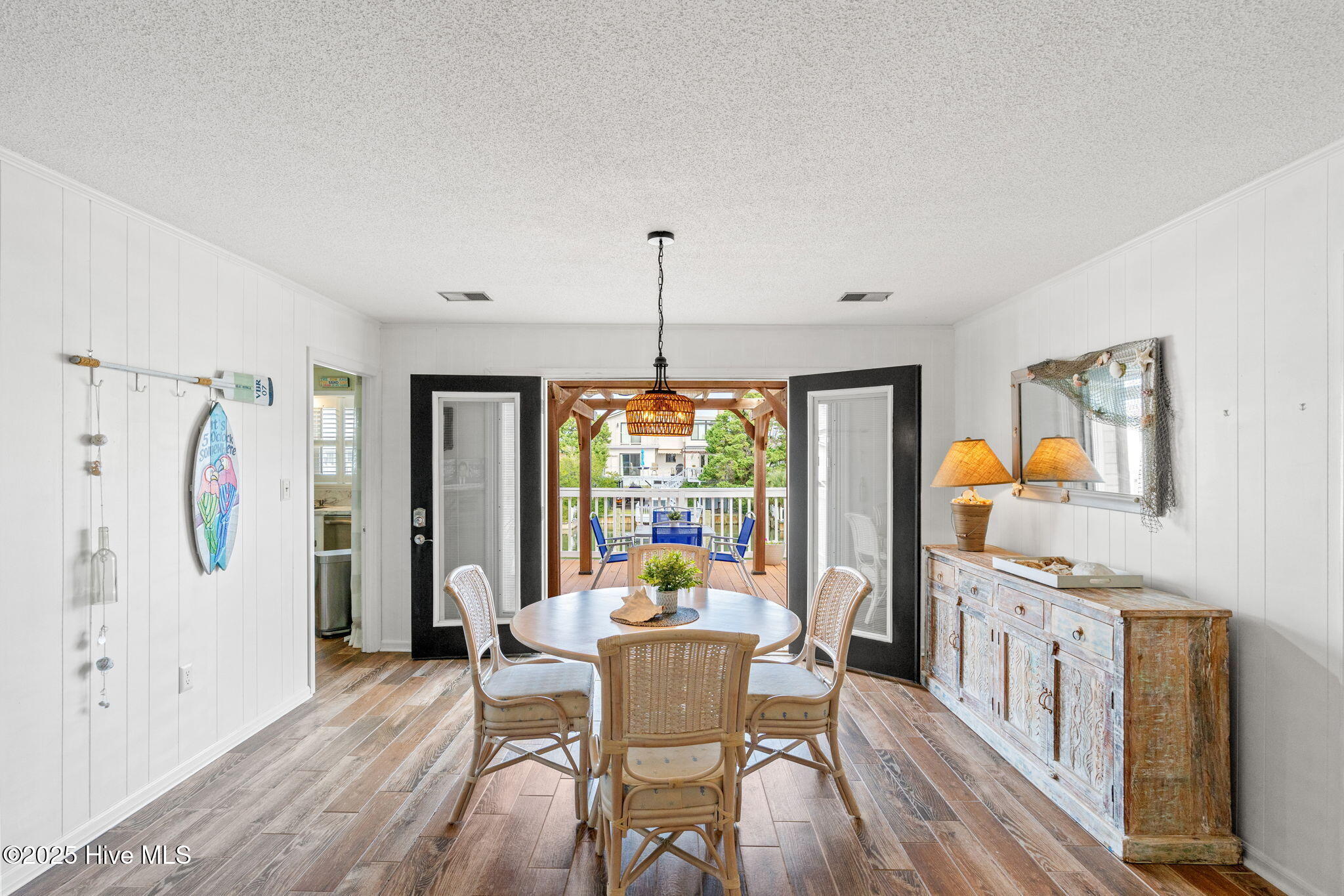 Dining room area open to rear deck overlooking canal