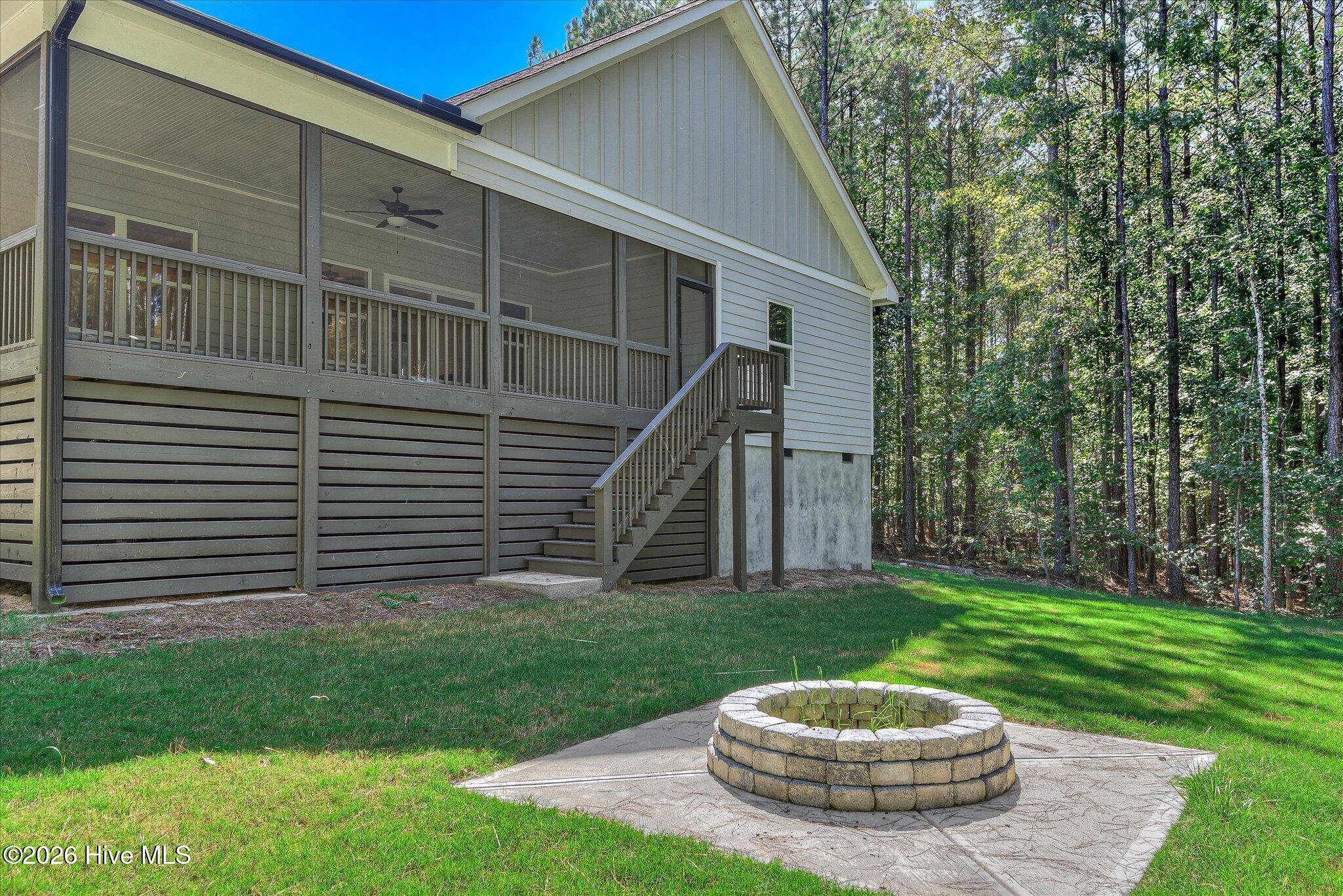 Large backyard with fire pit and trail to the lake, lot is dockable when water levels return to normal.