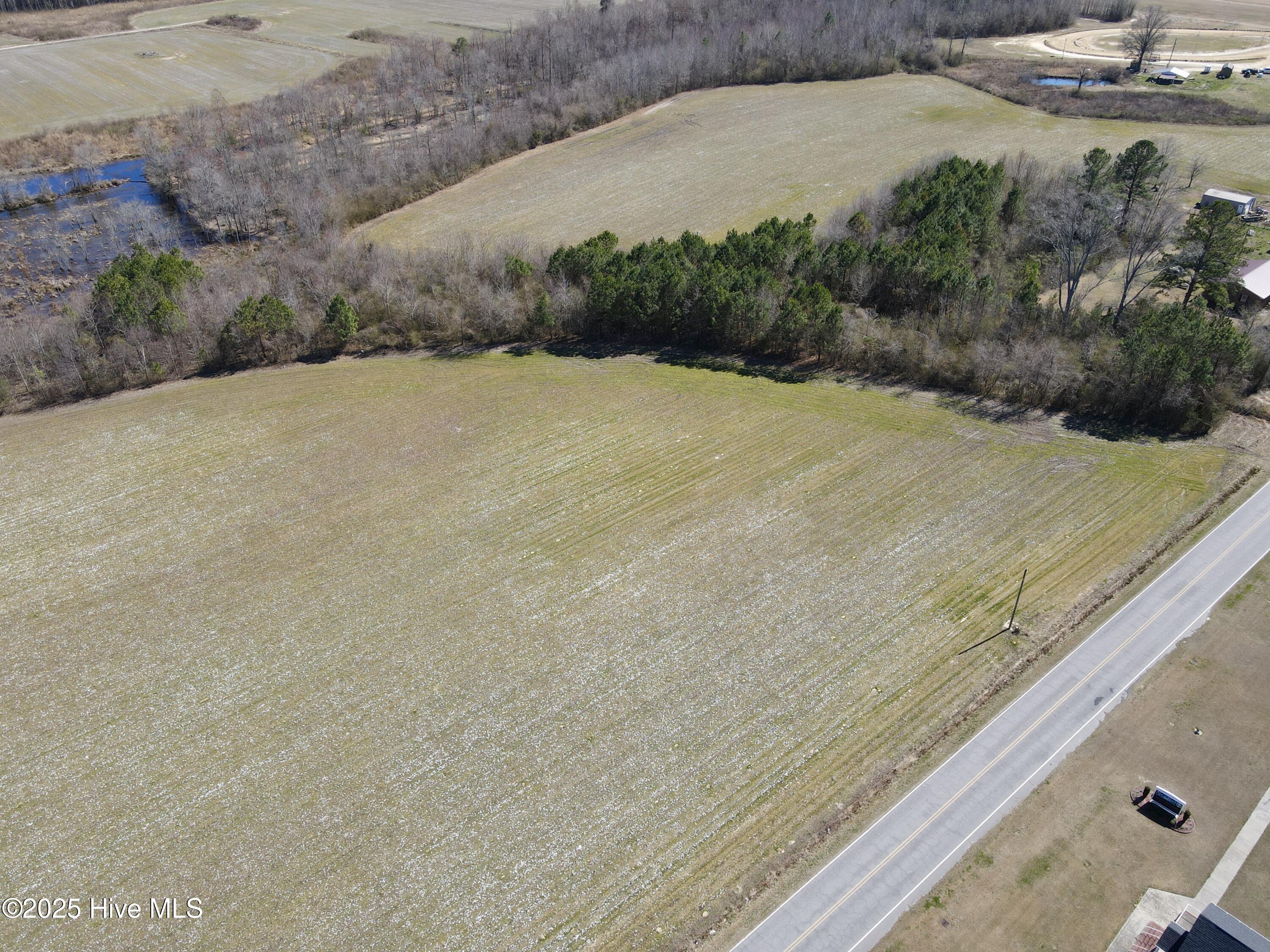 Just listed! Don't miss this rare opportunity to own a cleared, residential level lot spanning approximately 2.09 acres in the desirable Bear Grass community. This property offers endless potential, but act quickly! While there are light restrictions to consider, this property does already have a recent septic permit for a 3 bedroom conventional system. Conveniently located on a busy rural road, the property sits directly across from an active church, adding a sense of community to its appeal. For more details or to secure this unique opportunity, call today!