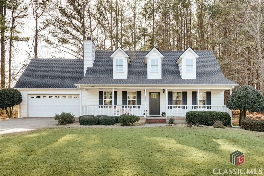 Who doesn’t love a classic Cape Cod on a cul-de-sac?! This charming home checks so many boxes: 3 bedrooms, 2.5 baths, approximately 1,600 square feet, primary suite on the main level, large 0.70 acre lot with fenced backyard, covered rocking chair front porch, two-car garage and more! Built in 2002, this home has tons of curb appeal and is tucked in the back of a cul-de-sac for a quiet and private setting. The main level features a vaulted living room with woodburning fireplace and tons of natural light, while the sunny kitchen and dining nook connect out to the back deck and yard. The two-car attached garage is located off the living room for easy entry. The spacious primary suite is on the main level, complete with a huge bathroom featuring a double vanity, soaking tub, walk-in shower and walk-in closet. The laundry closet and half bath are also conveniently located on the main level. Upstairs, you will find two more bedrooms and a second full bath. Enjoy your morning coffee on the front porch and cooking out on the back deck, while little ones and furry friends enjoy the fenced backyard. The home is conveniently located just minutes from Kroger Marketplace, shopping, restaurants and Athens Technical College, and just 15 minutes from the University of Georgia, downtown Athens and Piedmont Hospital. Come see today before it’s gone!