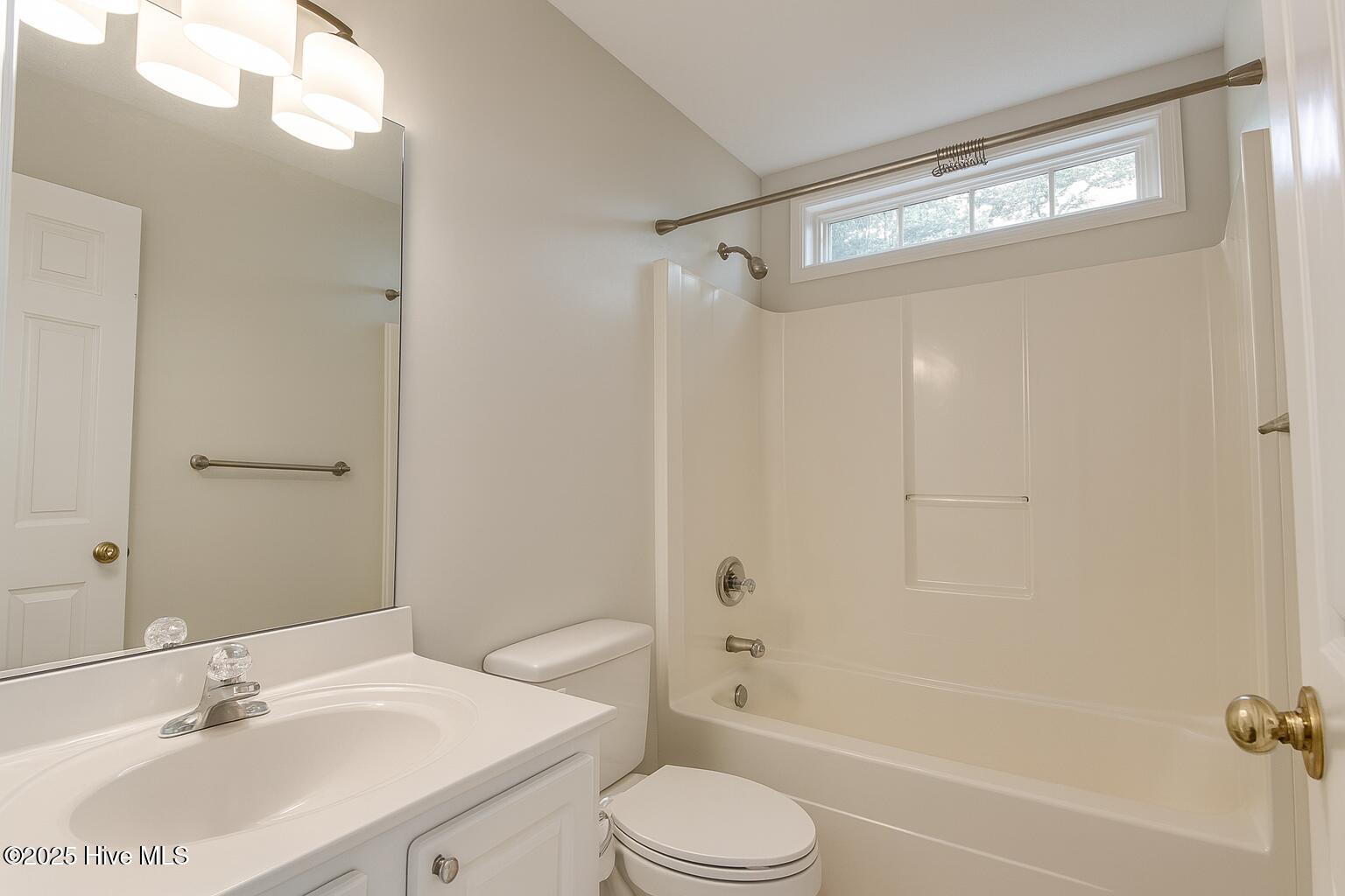 9117 Landing Drive SW, Calabash, NC 28467 – photo 21: Neutral Bathroom with Natural Light