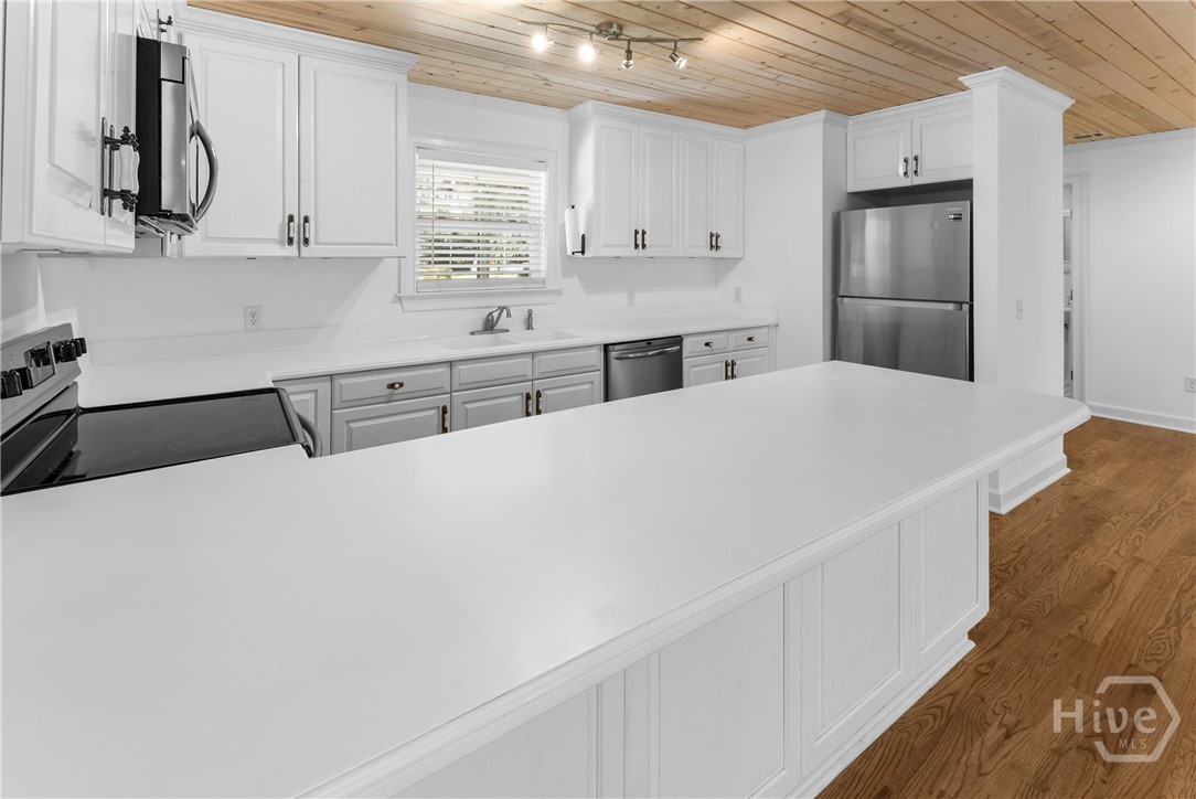 Classic all white kitchen with stainless appliances