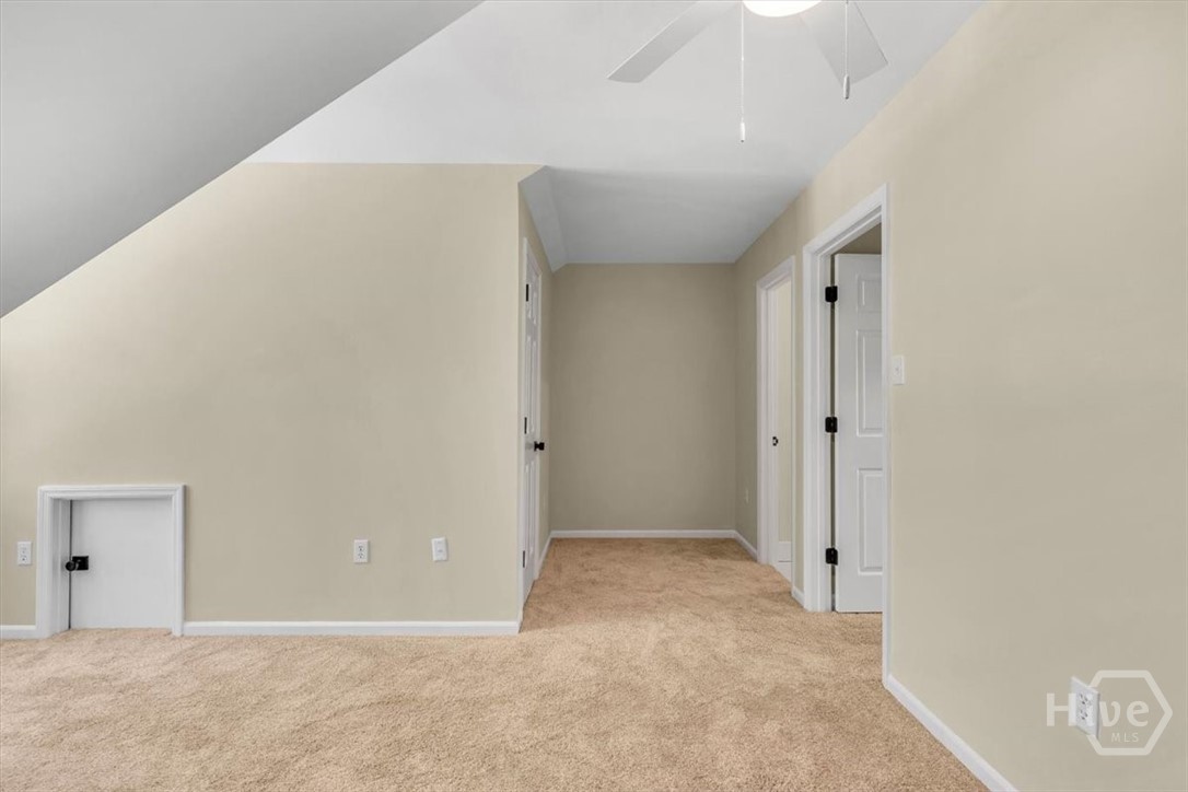 front bedroom with new carpet and ceiling fan