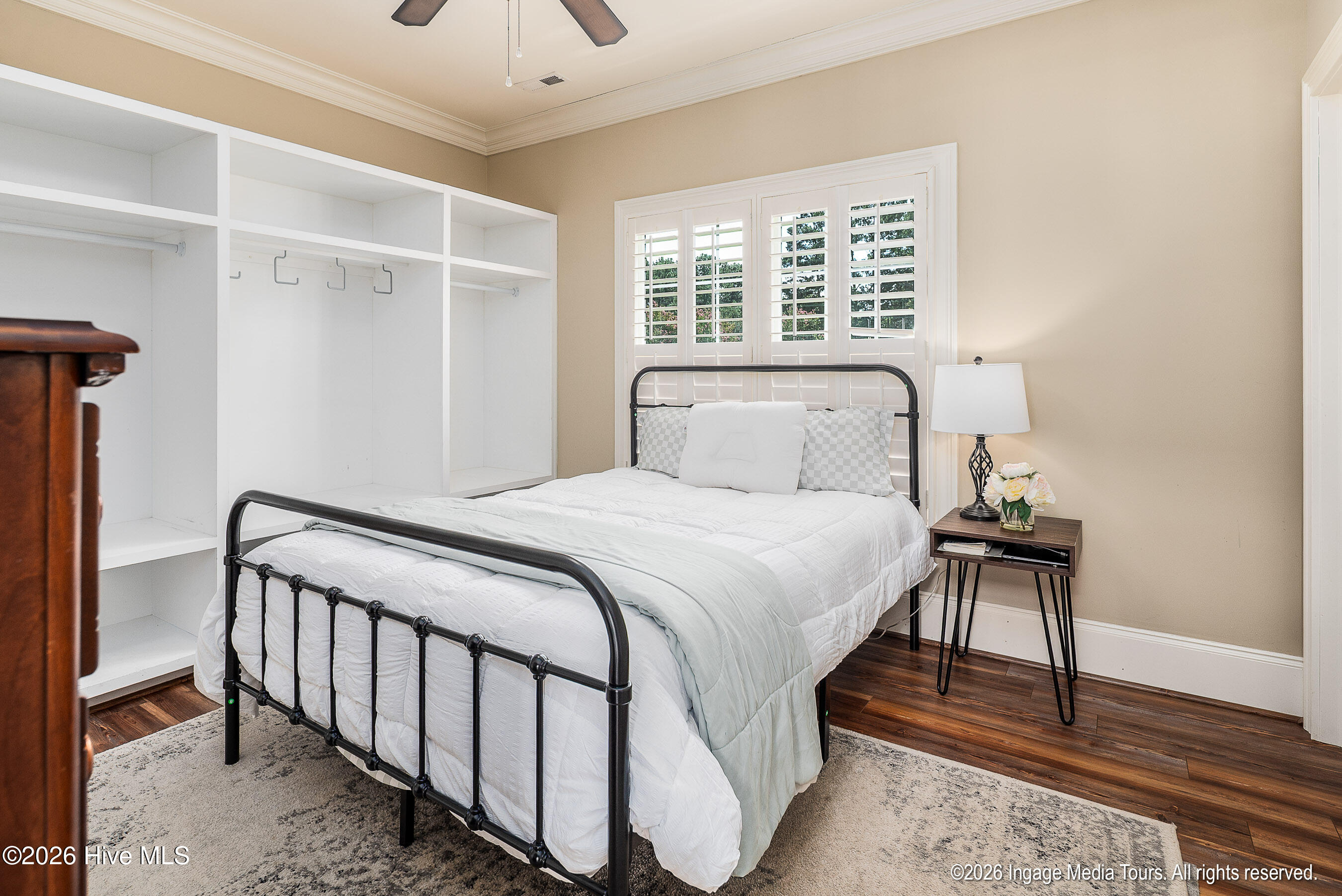 Guest house bedroom adjoins laundry storage area with private entrance.
