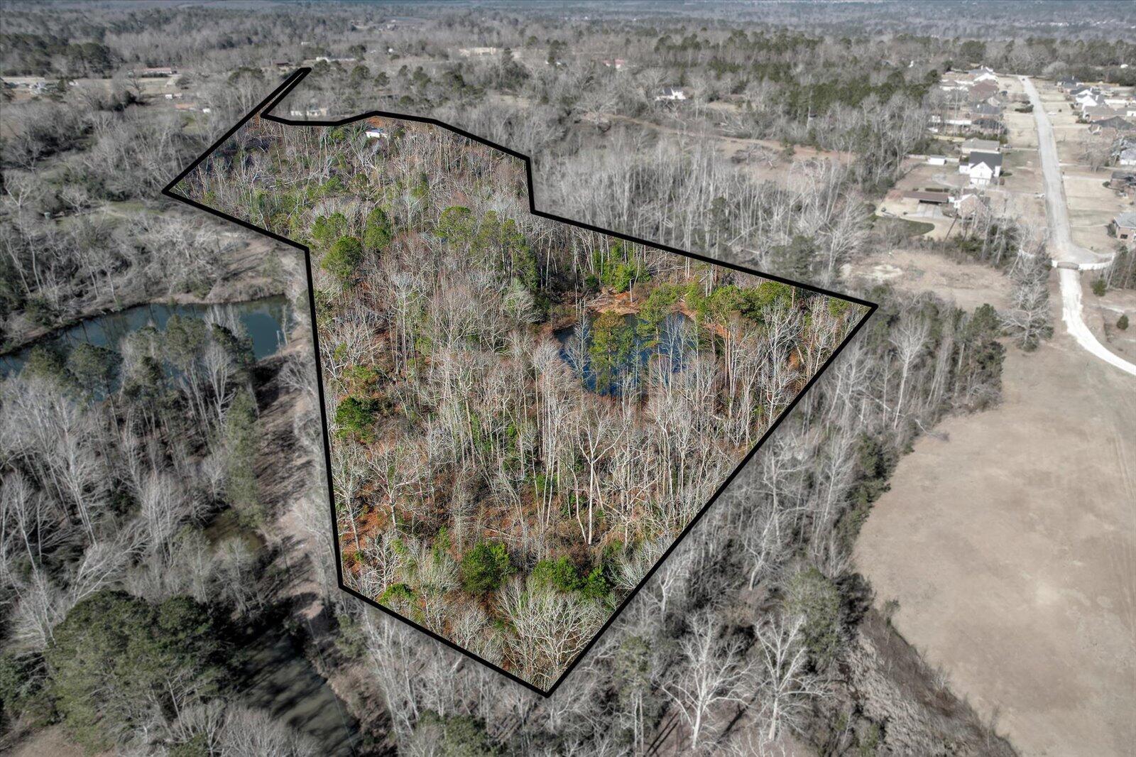 12+ Secluded Acres with Two Spring-Fed Ponds - A Private Retreat in Hephzibah s Growing Southern Market

Set in the rapidly growing Hephzibah area, this 12+ acre property offers a rare blend of privacy, natural beauty, and investment potential. Surrounded by a dense tree line, this expansive lot provides a peaceful escape while remaining conveniently close to the area's expanding amenities and development.

Two spring-fed ponds, brimming with fish, create a serene setting perfect for relaxation, recreation, or a future homesite. With a steady natural water source and a landscape rich in mature trees, this land is well-suited for a private estate, homestead, or recreational getaway.

As South Hephzibah continues to attract new growth, large parcels like this are becoming harder to find. Secure your own piece of Georgia's countryside with the added benefit of being in an up-and-coming location.