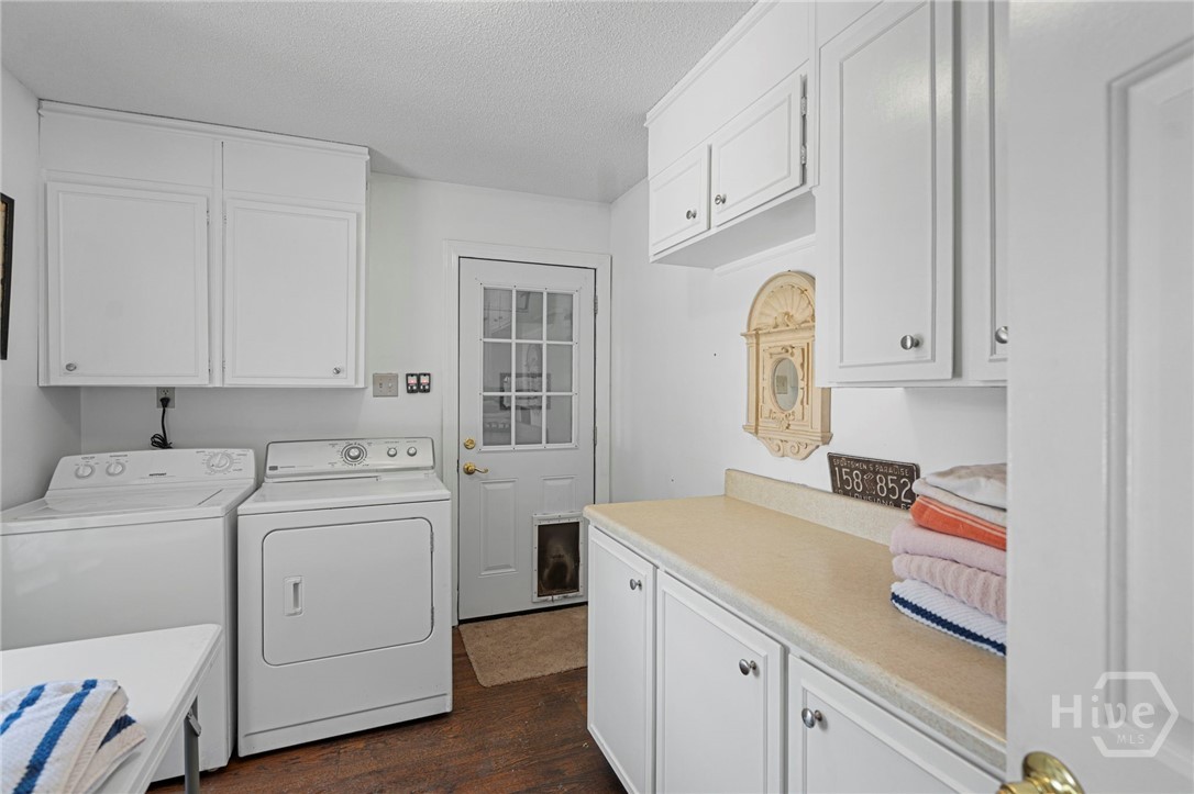 Utility laundry room leads into garage