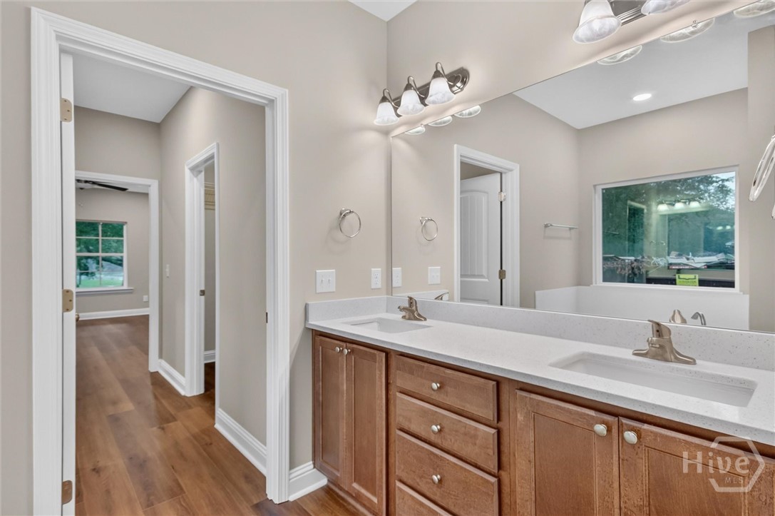 Primary bathroom showcasing the hallway with dual closets before entering the ensuite