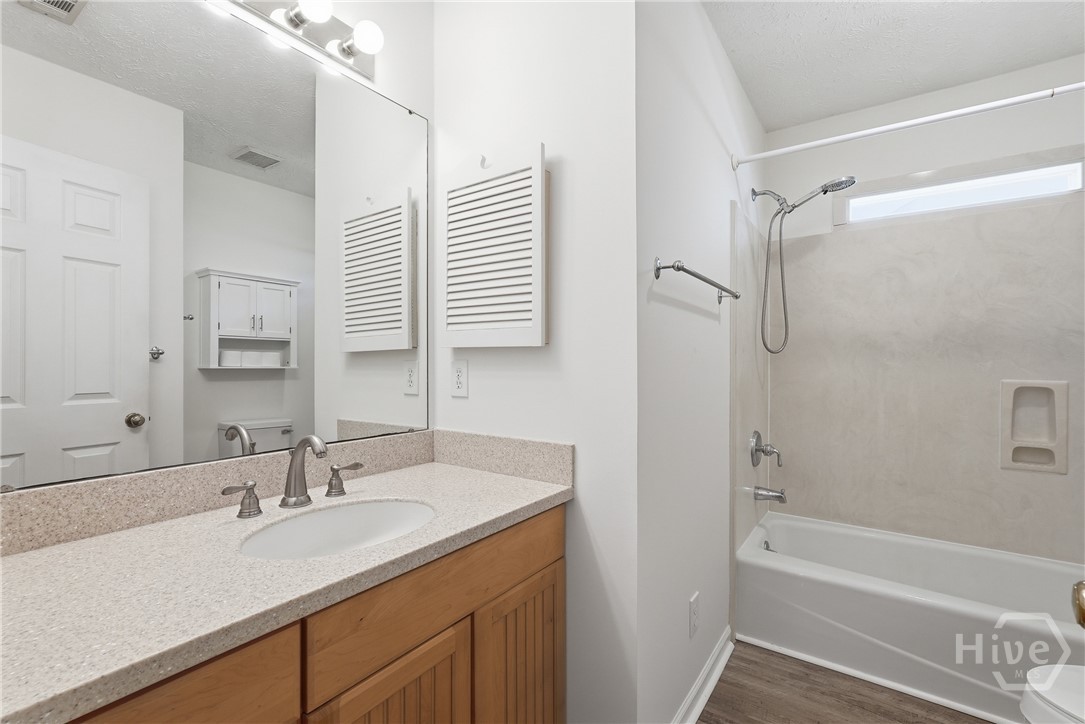 Hall bathroom has solid surface counters and LVP floors.